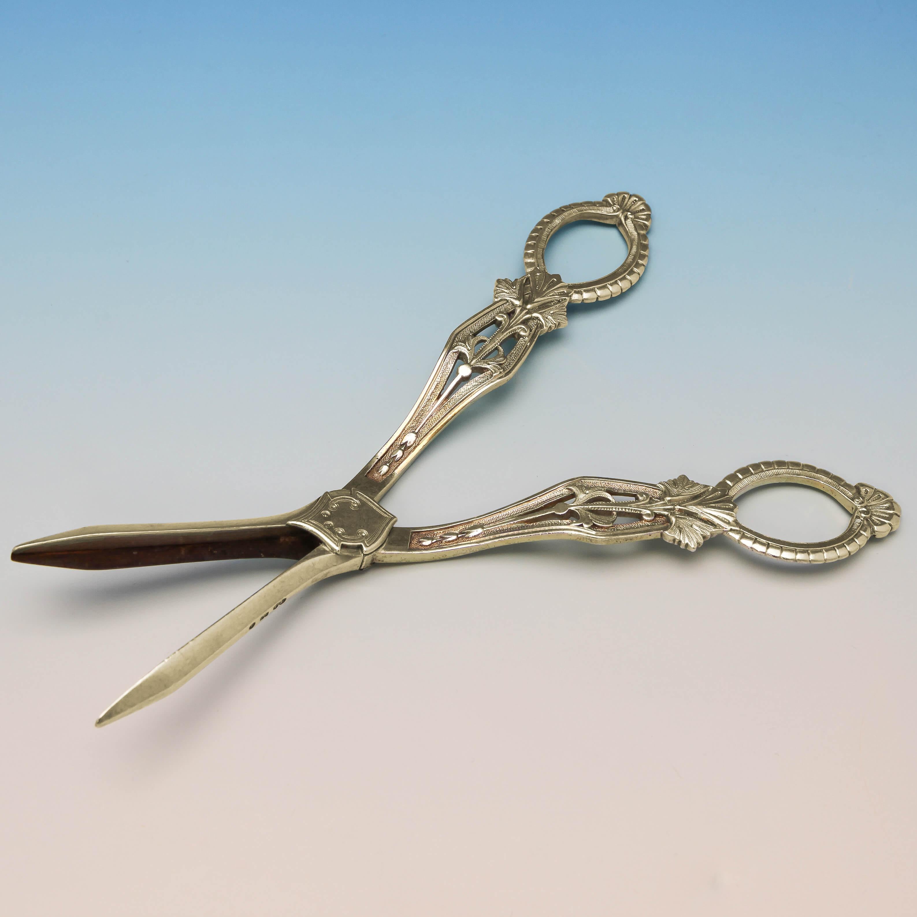 Hallmarked in Birmingham in 1876 by Elkington & Co., this pretty, and ornate, pair of Antique, Victorian, Sterling Silver Grape Shears, have fine decoration on both sides and the original gilding. The grape shears measure 7.5