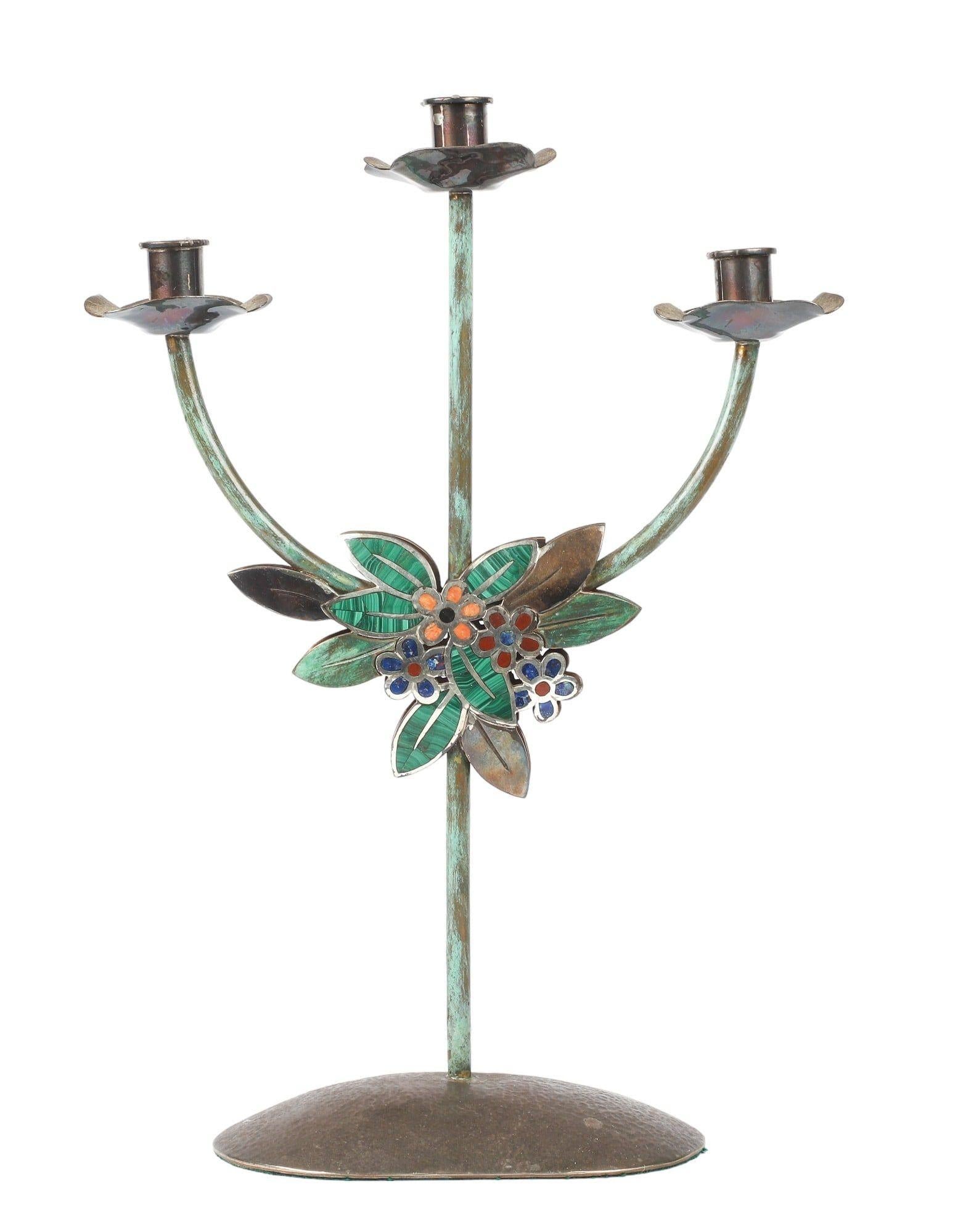 Introducing the exquisite mixed metal & stone candelabra by Emilia Castillo, a true testament to the artistry of Mexican craftsmanship. This stunning piece is a harmonious blend of sterling silver, silver plate, copper, and stone, meticulously