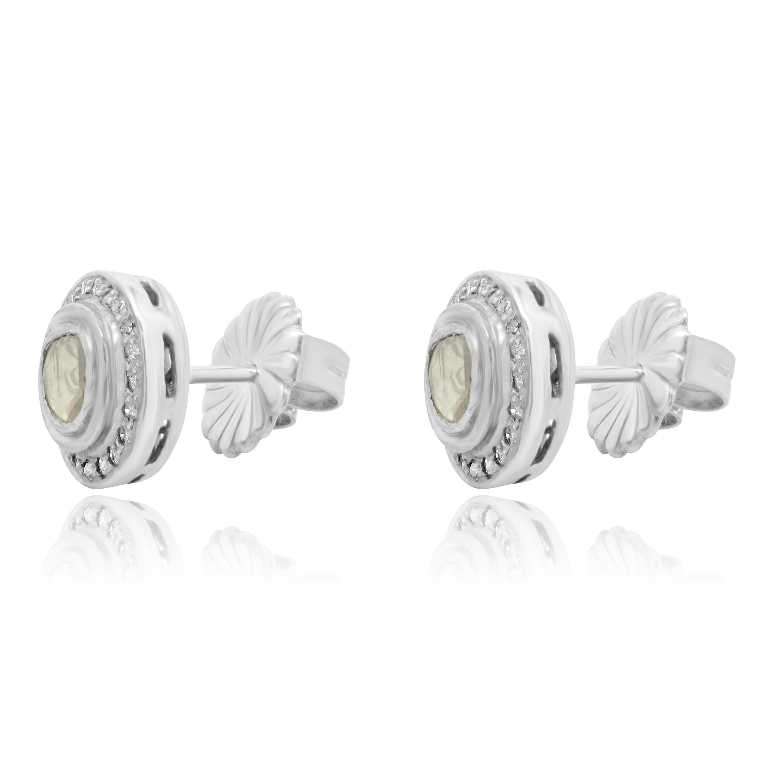 Material: sterling silver
Diamonds: 2 sliced cut = 0.45cttw
Color: K
Clarity: I3
Diamonds: 40 round single cut = 0.15cttw
Color: H / I
Clarity: I1
Dimensions: earrings measure approximately 11.6mm in diameter
Fastenings: friction backs
Weight: 3.88