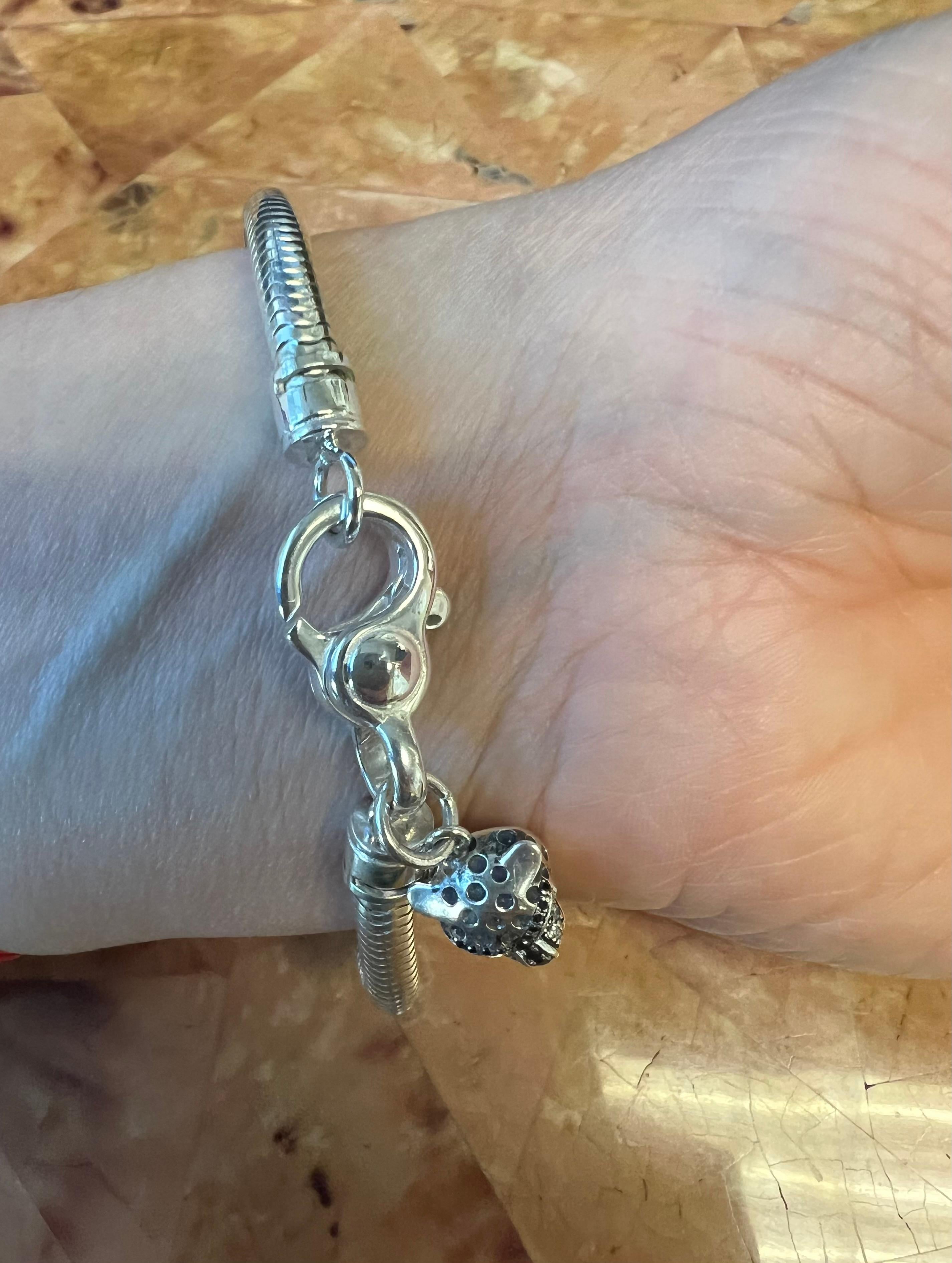 Drape your wrist in the exotic allure of our Sterling Silver Snake Chain Bracelet featuring a captivating Cheetah charm. This 8.5-inch bracelet seamlessly blends sophistication with the untamed spirit, showcasing a meticulously crafted snake chain