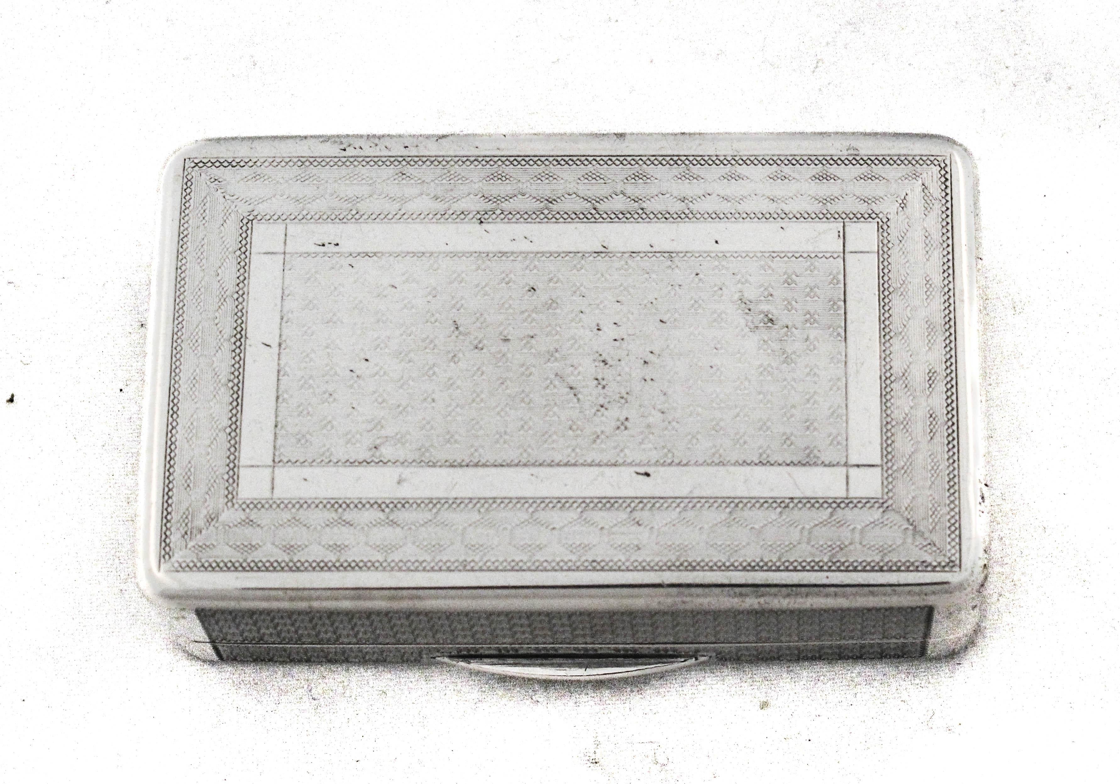A finely crafted sterling silver snuff box featuring a sleek rectangular form with crisp, clean lines. The lid showcases an intricate engine-turned pattern with a geometric diamond motif at the center, bordered by finely hatched detailing. The