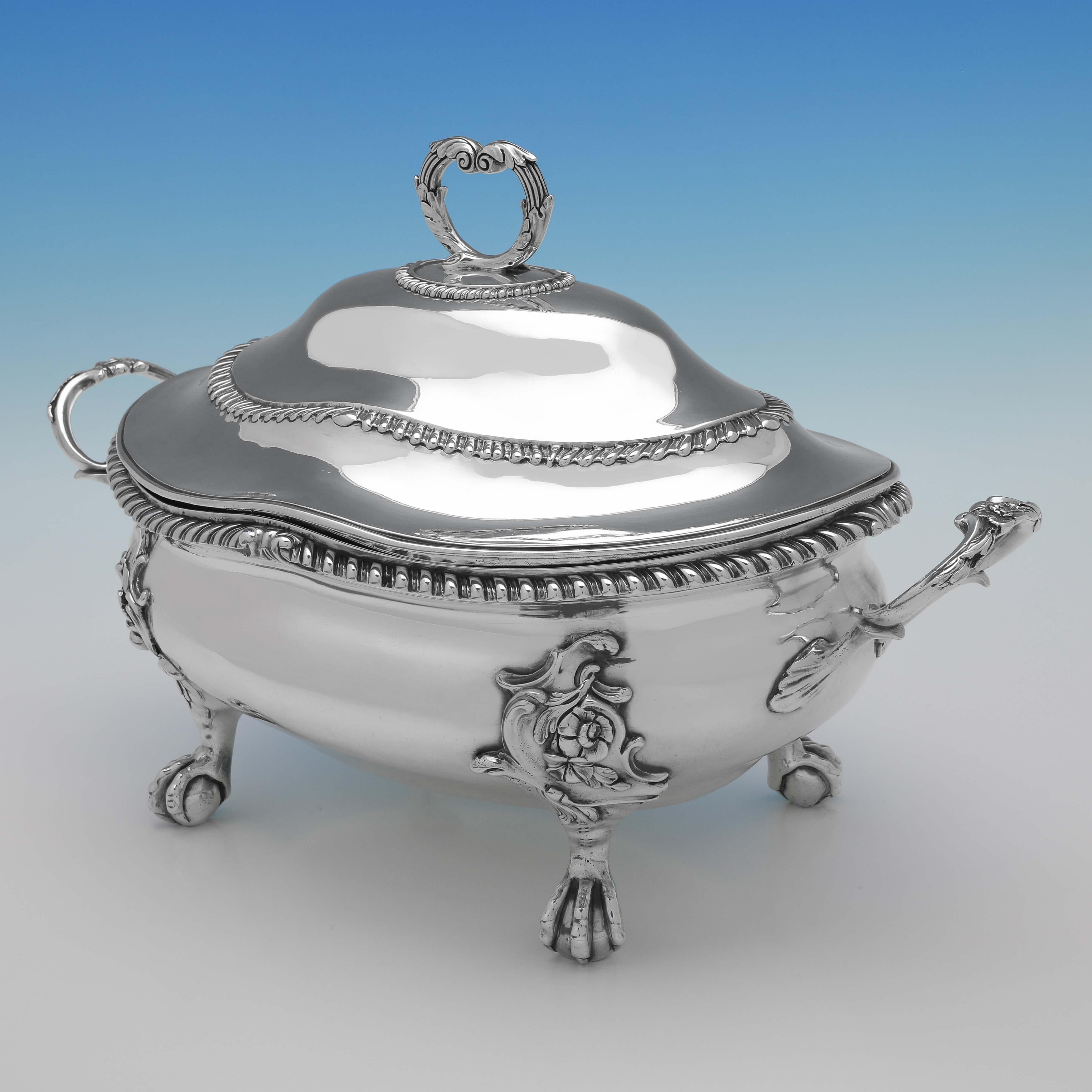 Hallmarked in London in 1766 by Lewis Herne & Francis Butty, this handsome, George III, Antique Sterling Silver Soup Tureen, features gadroon borders on the body and lid, and ornate handles and feet. The soup tureen measures 9.75