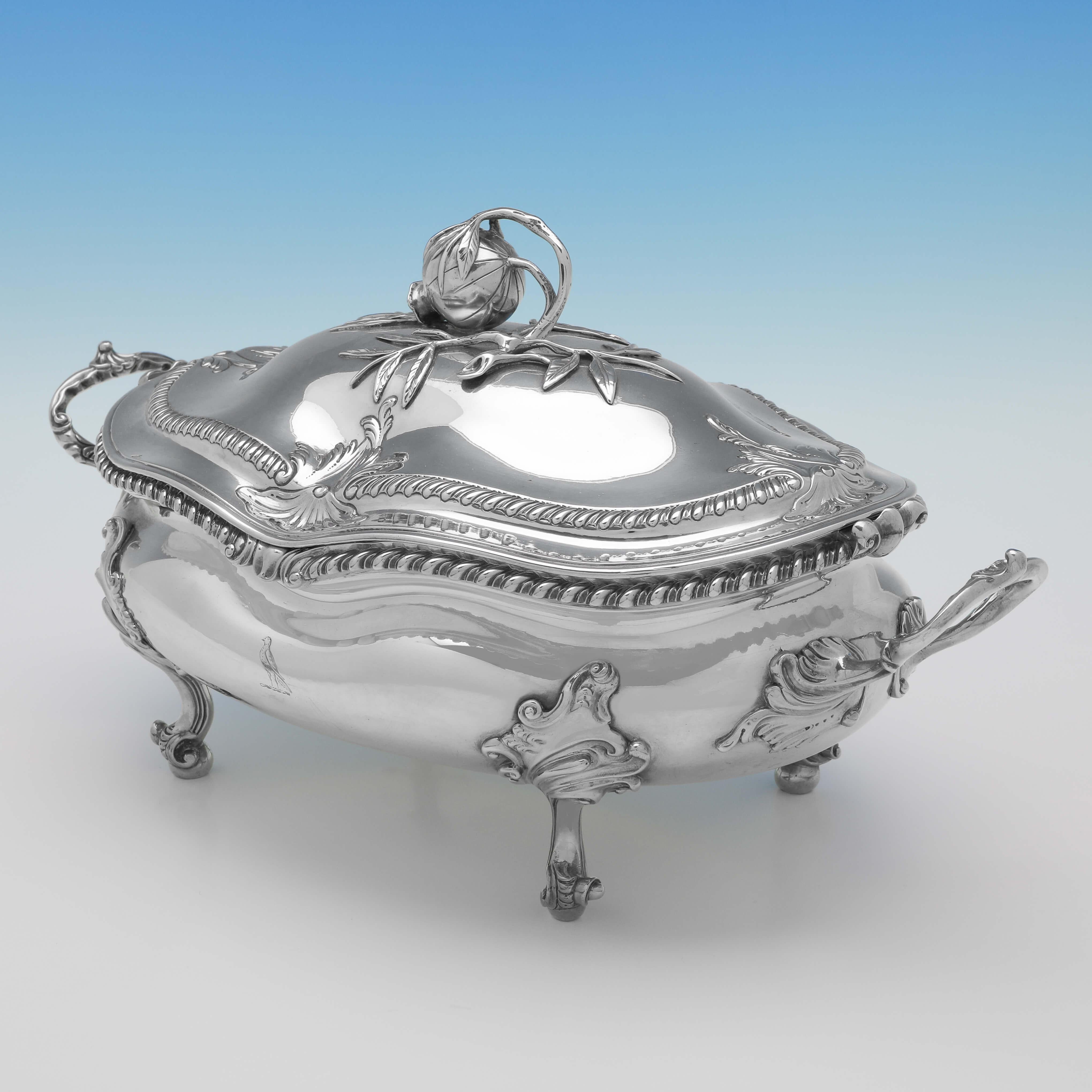 Hallmarked in London in 1772 by Sebastian & James Crespell, this wonderful, George III, Antique Sterling Silver Soup Tureen, stands on four scroll feet, and features gadroon borders, acanthus decoration, an engraved crest, and a pumpkin finial. The