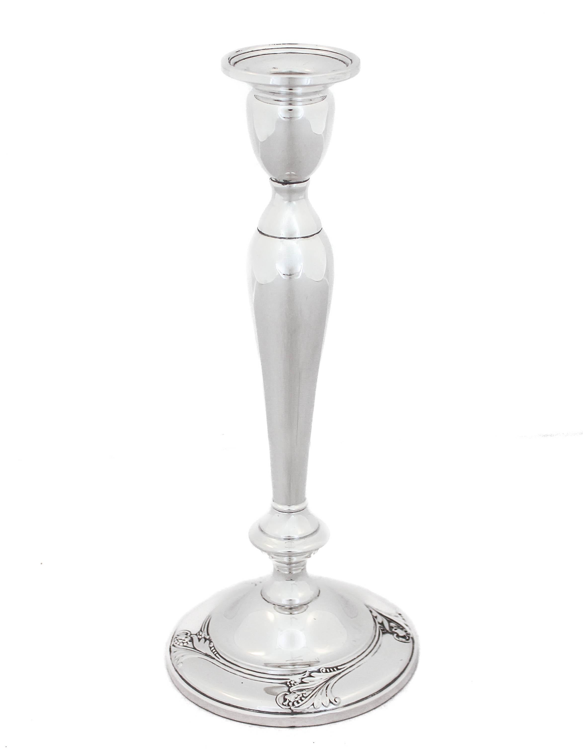 Being offered is a pair of sterling silver candlesticks in the “Spring Glory” pattern by International Silver, circa 1942.  Sleek and feminine, there’s a floral design around the base.  There are four around the base and they are raised.  The body
