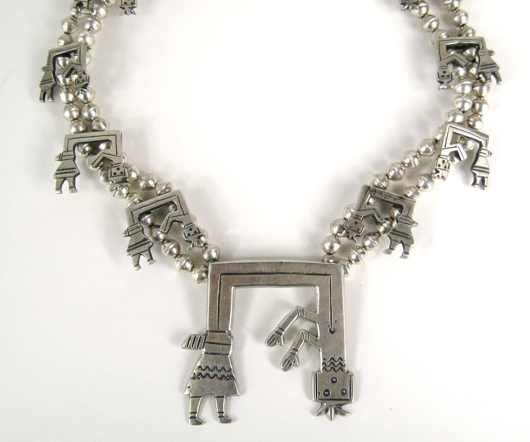 Stunning large Sterling silver Hopi Native American squash necklace. Large Hopi Figure as the centerpiece of this fantastic necklace. The necklace measures 29 in. end to end. It has a total of 13 hopi figures on the is masterpiece! Center drop