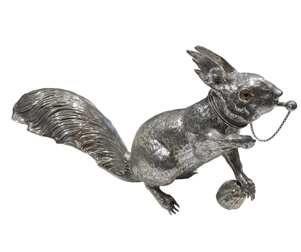 Exceptional large and realistic solid sterling silver cocktail shaker in the form of a squirrel. Focused, holding a nut in its paw and is about to pounce at the slightest alert. The shaker is finely chiseled with many realistic details. The head is