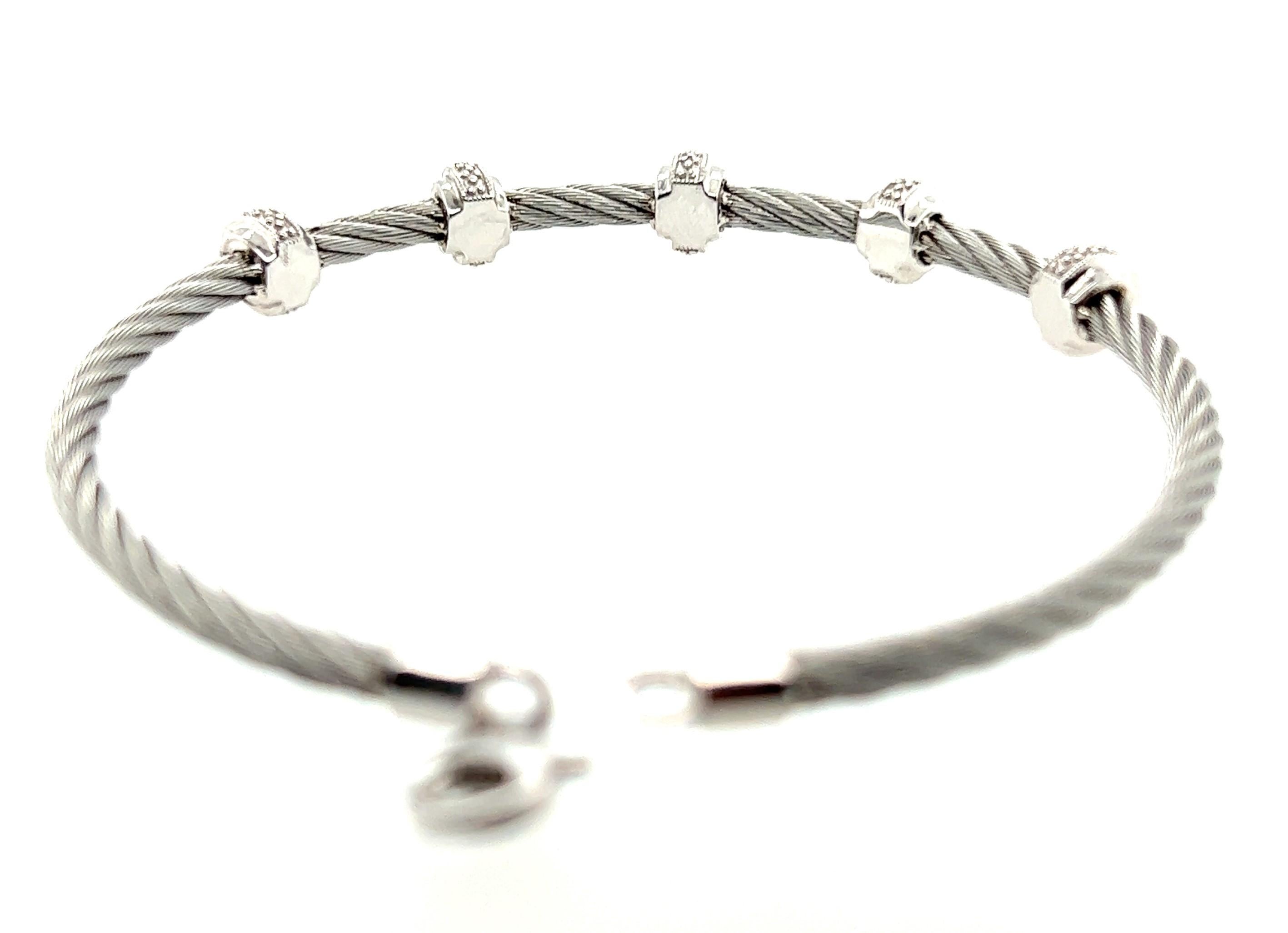 Sterling silver and stainless steel bracelet with lobster claw closure.

5 Sterling Silver Rondelles measure 3/16 inch each.
5 Rondelles measure approx. 2 inches across wrist.
Rondelles sit equadistant on a steel cable.
Diamonds are .10 total carat