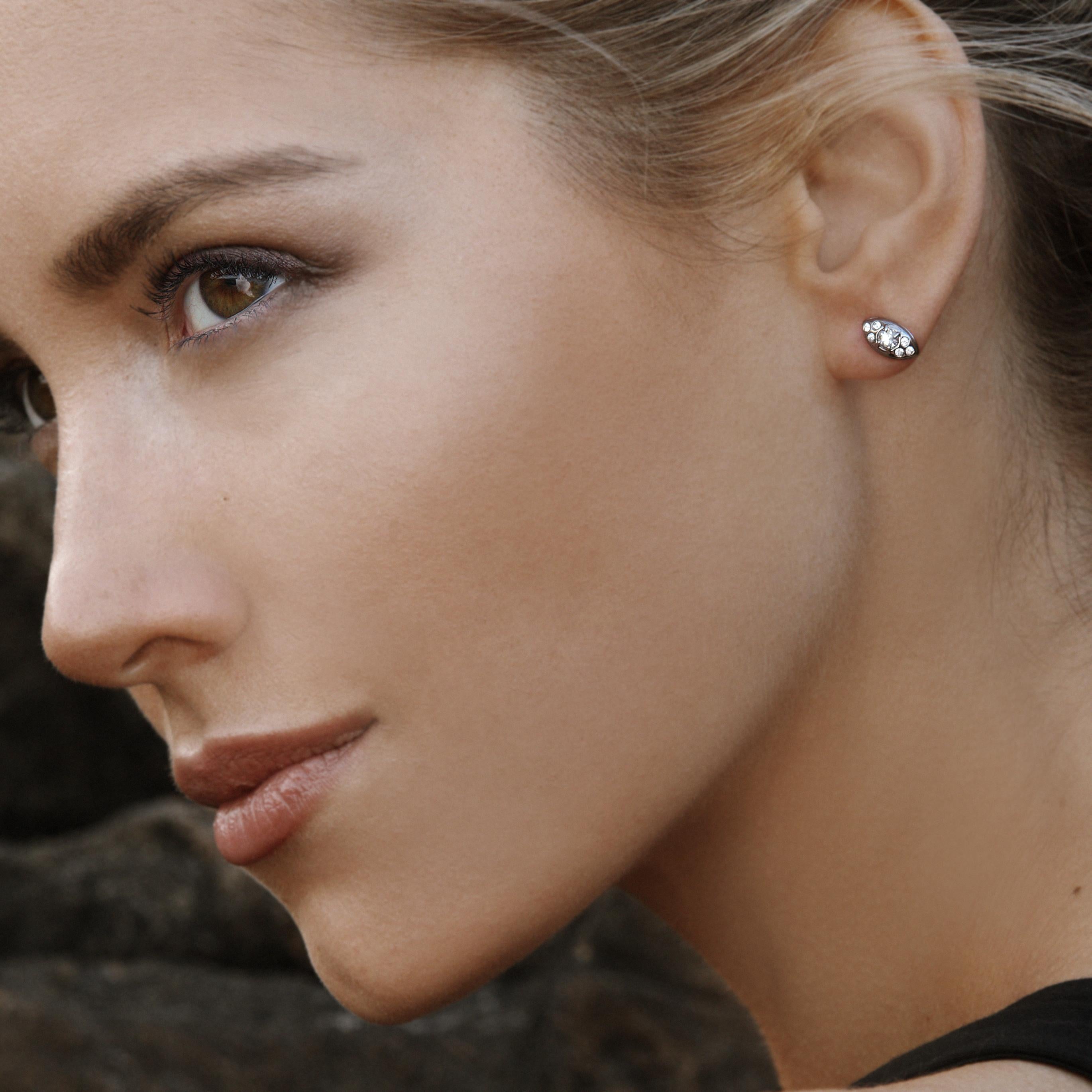 In blackened sterling silver with white sapphires, this sparkly understated earring has an elegant presence. The Singing Pillow stud earring is great on the second and third ear holes as it is intentionally sculpted to curve around the