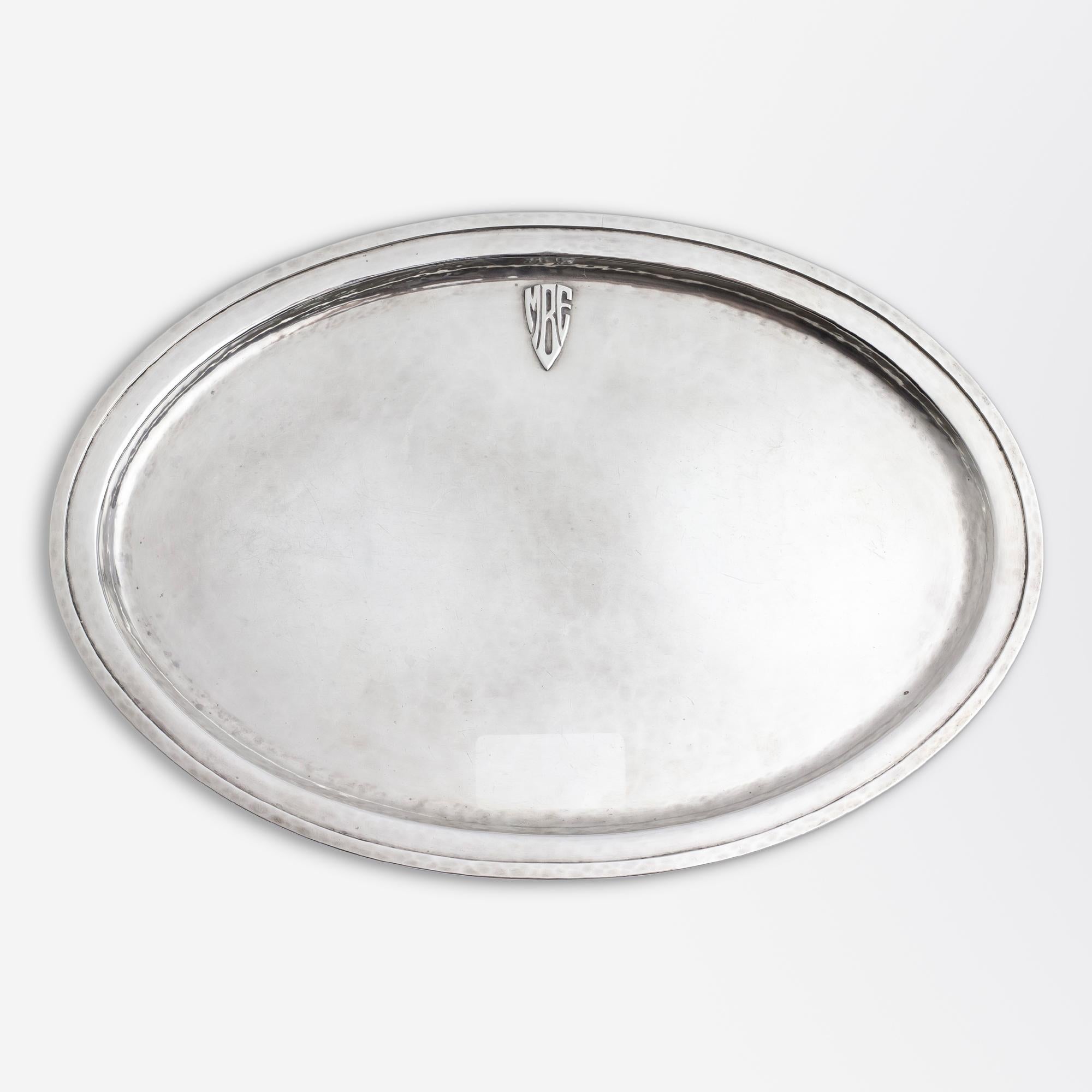 This hand wrought sterling silver sugar and creamer with matched oval tray is crafted by Chicago maker, Lebolt & Company. The three piece set dates to the American 'Arts & Crafts' period of the early 20th Century and features a period monogram of