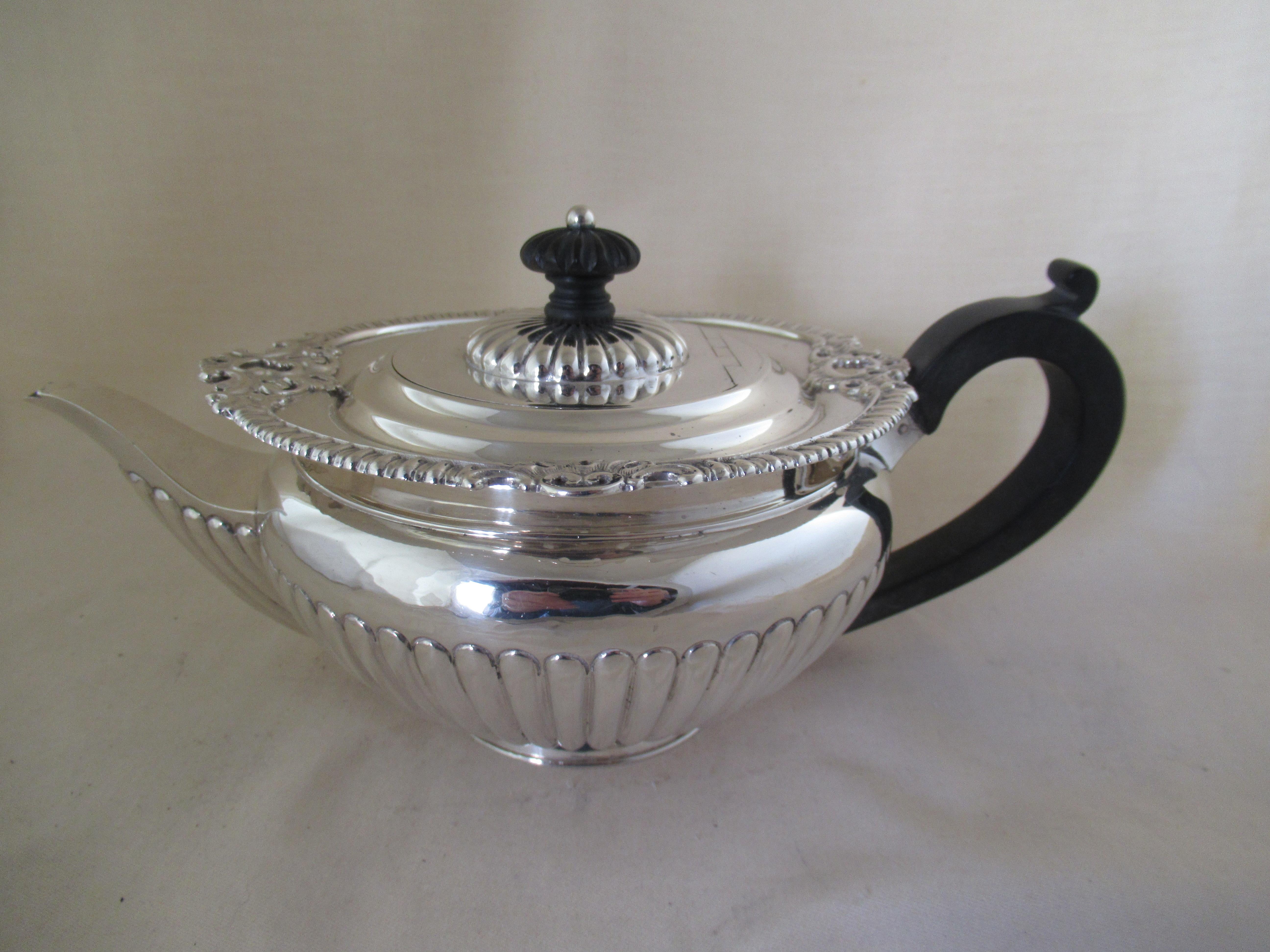 Sterling Silver SUPERB VICTORIAN TEAPOT 
Identified with English Hallmarks, applied by the Birmingham Assay Office.
 
 Hallmarks:- Lion - Sterling silver guarantee 
 Lower case v - Date letter for Birmingham 1895 
 Anchor - Mark of the