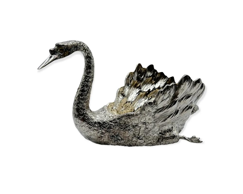 Sterling silver Swan bird by Buccellati

Bird is in glide mode with flipped back paddle feet and head tilted slightly to side with intent gaze. Eyes glass. Extra fine detail in the feathers from the scaly neck to the down tail plums. 
Marked
