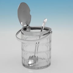 Sterling silver swing handled jam pot with spoon made by Hukin & Heath in 1925