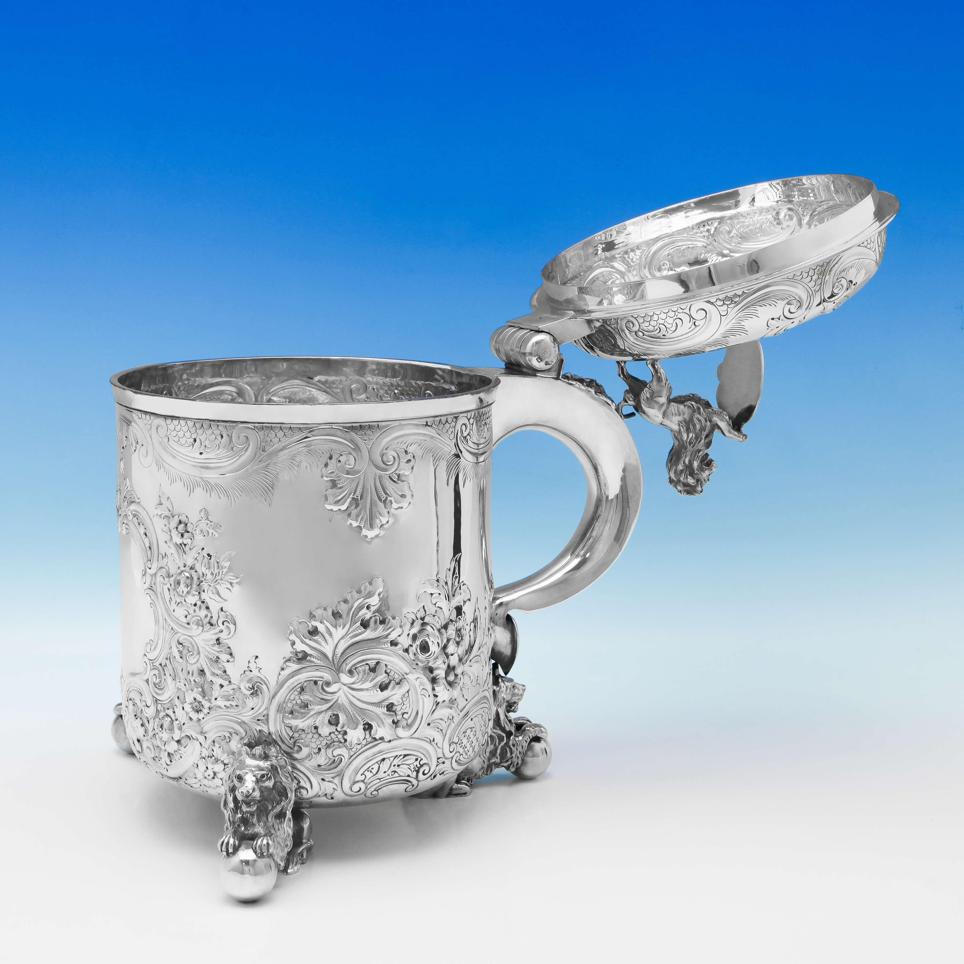 Hallmarked in London in 1900 by Elkington & Co., this impressive, Victorian, antique, sterling silver centrepiece, could be used as a trophy, a wine cooler, or as an oversized beer tankard. The centrepiece stands on thee recumbent lion feet, their
