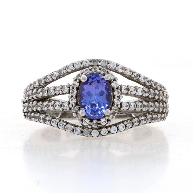 Size: 8 1/4
Sizing Fee: Up 1 size for $30

Metal Content: Sterling Silver

Stone Information
Natural Tanzanite
Treatment: Routinely Enhanced
Cut: Oval
Color: Purple

Natural White Topaz
Cut: Round

Style: Solitaire with Accents