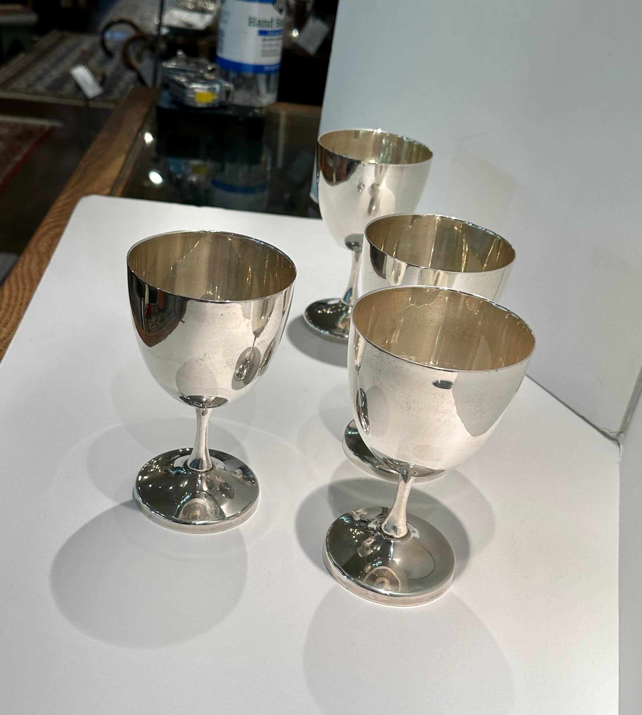 Set of 4 sterling silver wine goblets.
Beautifully proportioned, hand made by Taxco artisan, Mexico.  
Marked underside.  Excellent condition.