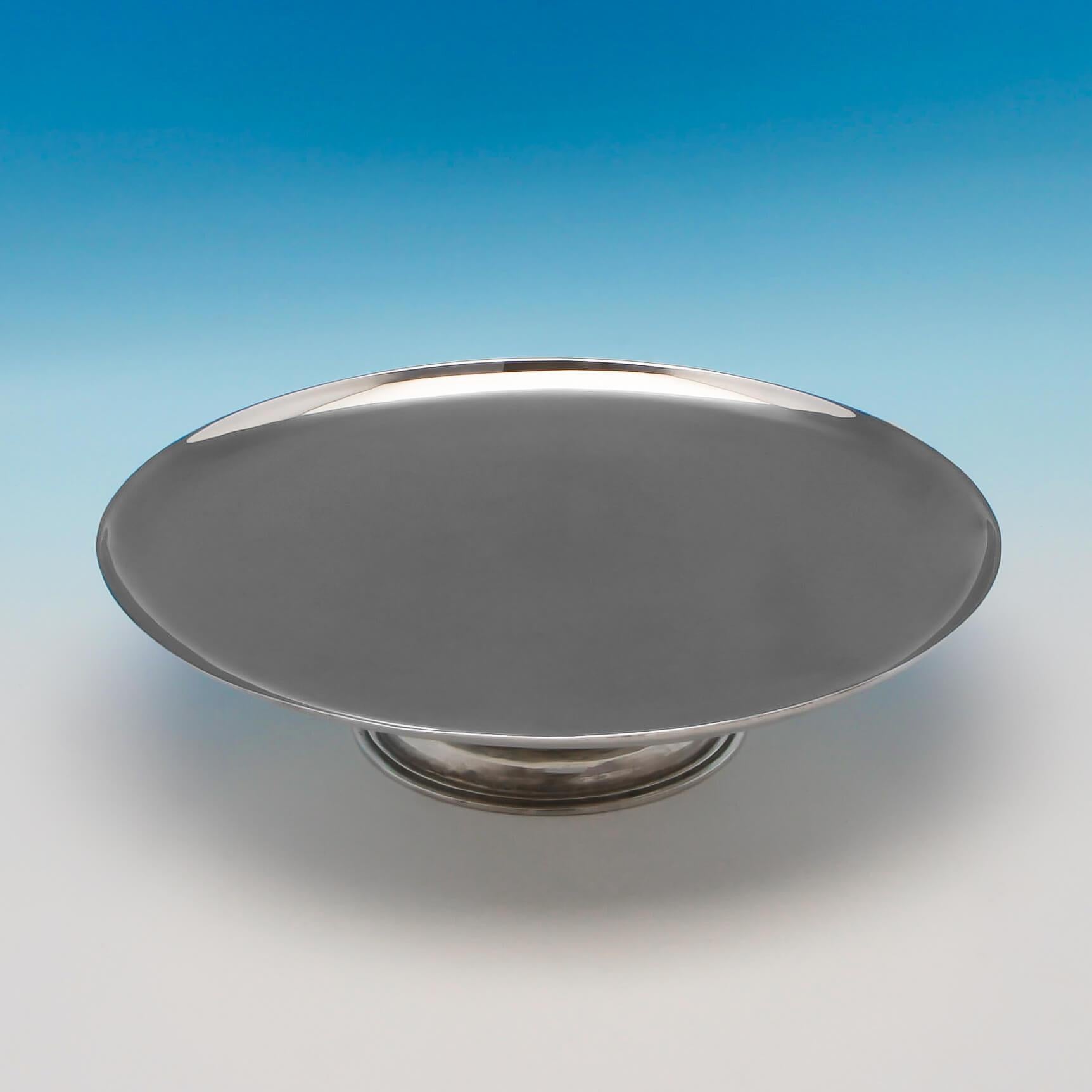 Hallmarked in London in 1934 by Parson Brothers for Tessiers, this fine quality, George V, Sterling Silver Tazza, is plain in style, featuring a hand hammered finish to the pedestal foot, and reed detailing. The tazza measures 2.5”(6cm) tall, by
