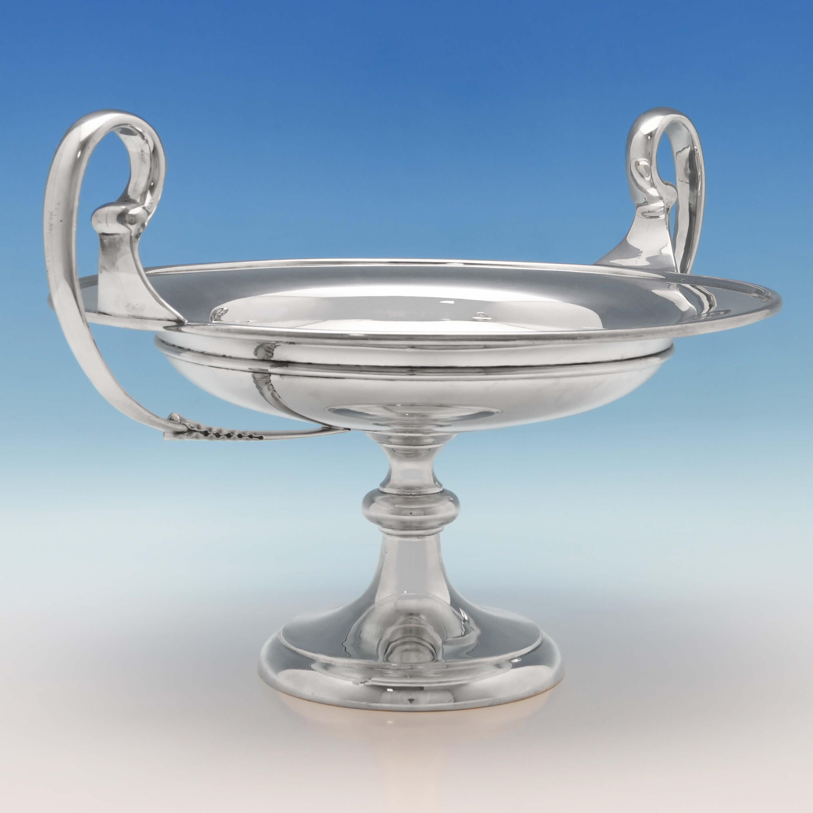 Hallmarked in London in 1914 by Pearce & Sons, this fantastic and generously proportioned, George V, Antique, Sterling Silver Tazza, is plain in style, standing on a pedestal base, and featuring harp handles with acanthus detailing. The tazza