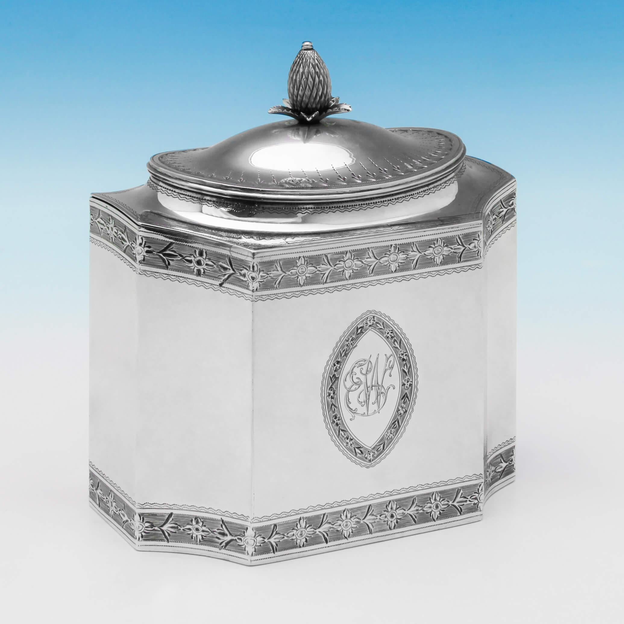 Hallmarked in London in 1790 by John Robins, this fine, exceptional quality, George III, antique, sterling silver tea caddy, has striking brightcut engraving around the base, top and lid, and a silver pineapple finial. On the front side there is a