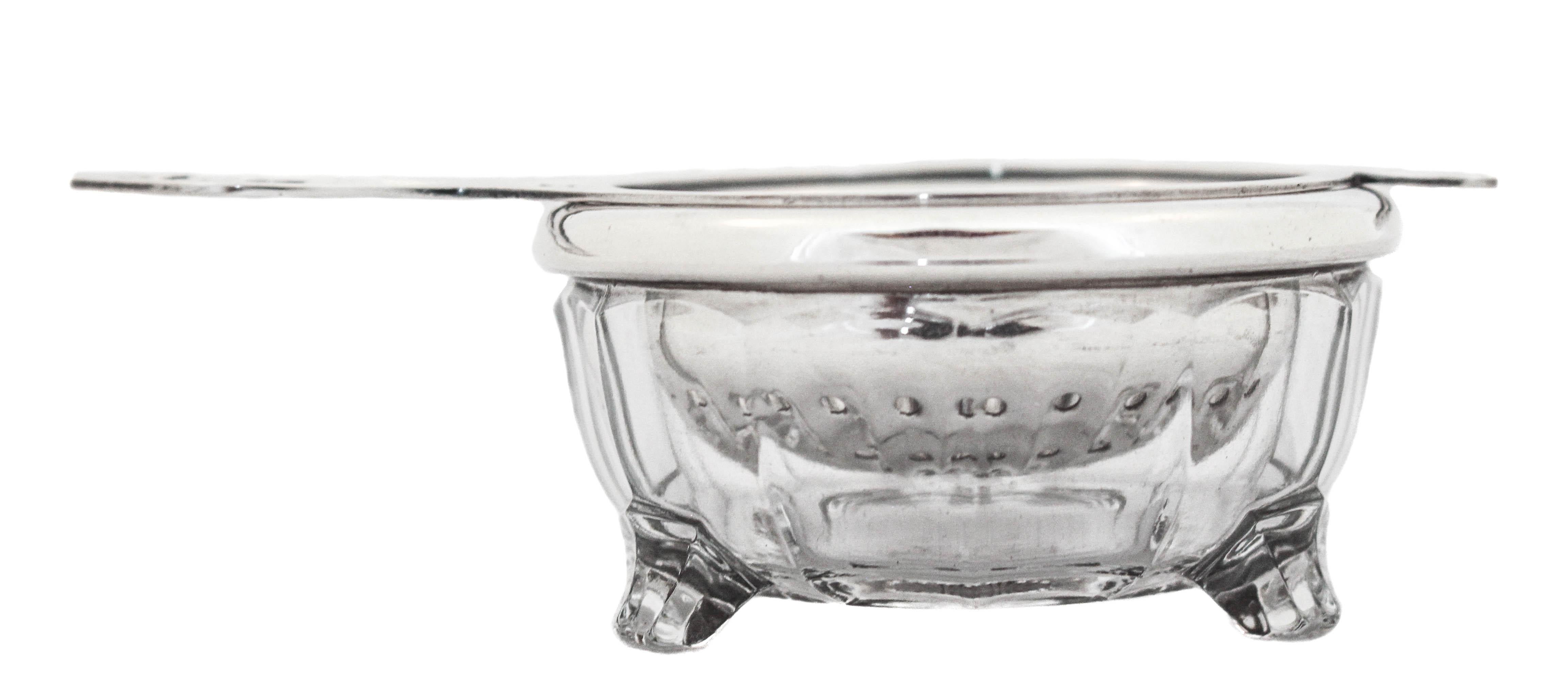 Attention fellow tea lovers this darling tea strainer is sterling silver! The crystal bowl also has a sterling silver rim with three feet and a paneled design. When you’re done using the strainer, simply put it on the bowl and it collects the access