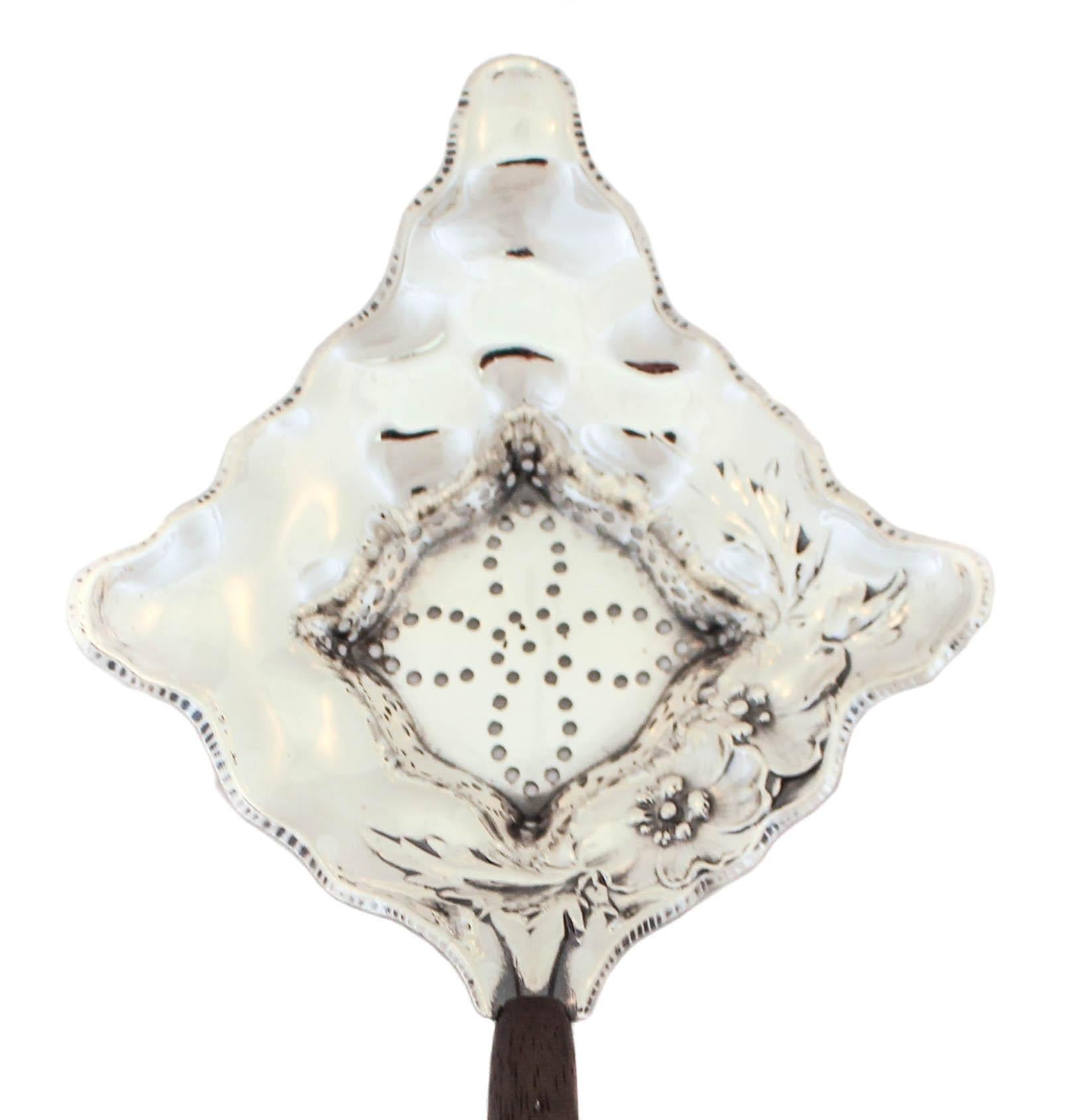 If you’re serious about your tea like I am, you’re going to love this sterling silver tea strainer. It has a wood handle and the rest is sterling silver. The top part is triangular shaped and has piercing in the center. An elegant way to serve tea,