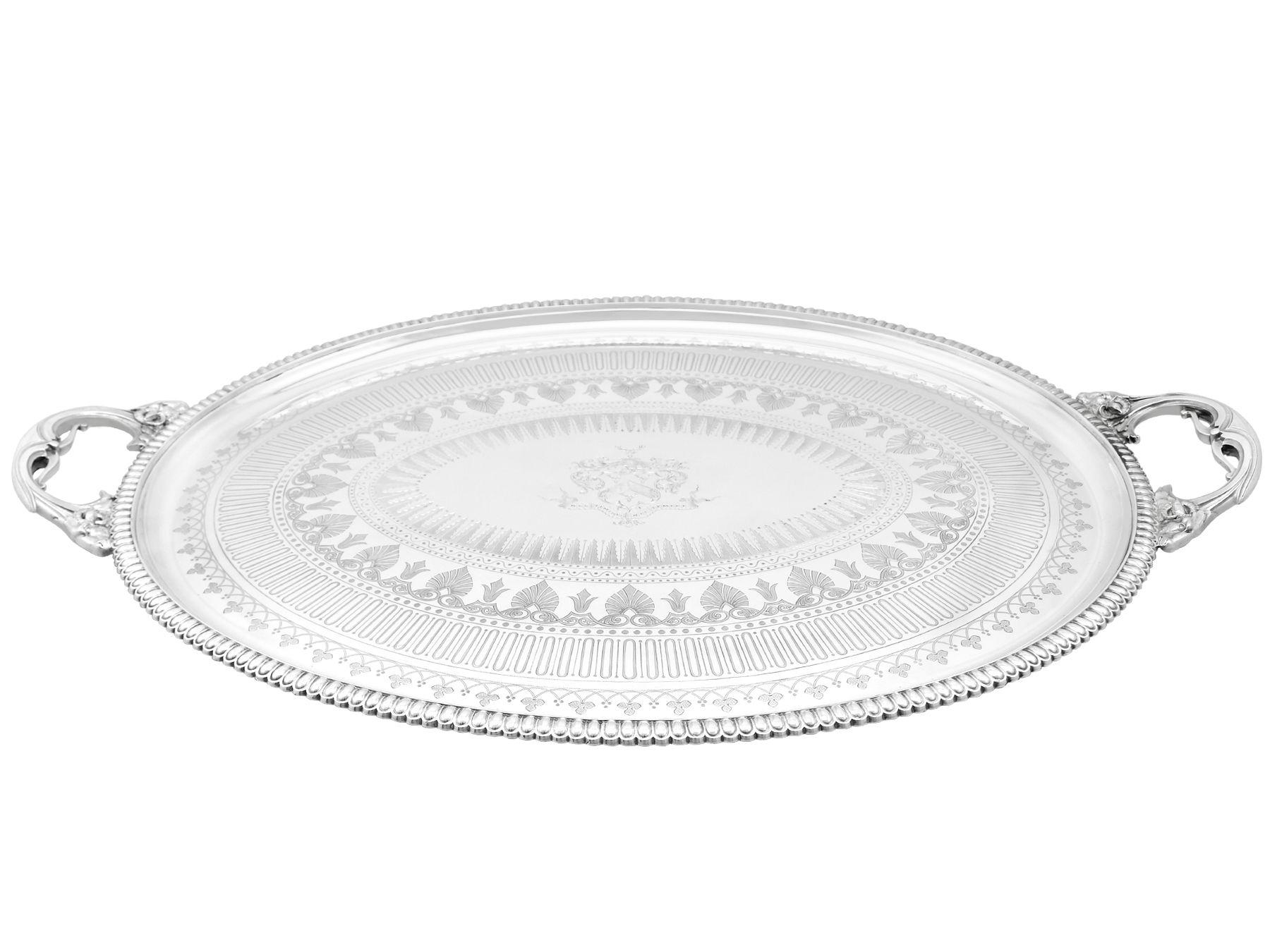 A magnificent, fine and impressive antique Victorian English sterling silver tea tray made by Elkington & Co; an addition to our silver tray collection.
This magnificent antique Victorian sterling silver tray has an oval form.
The surface of the