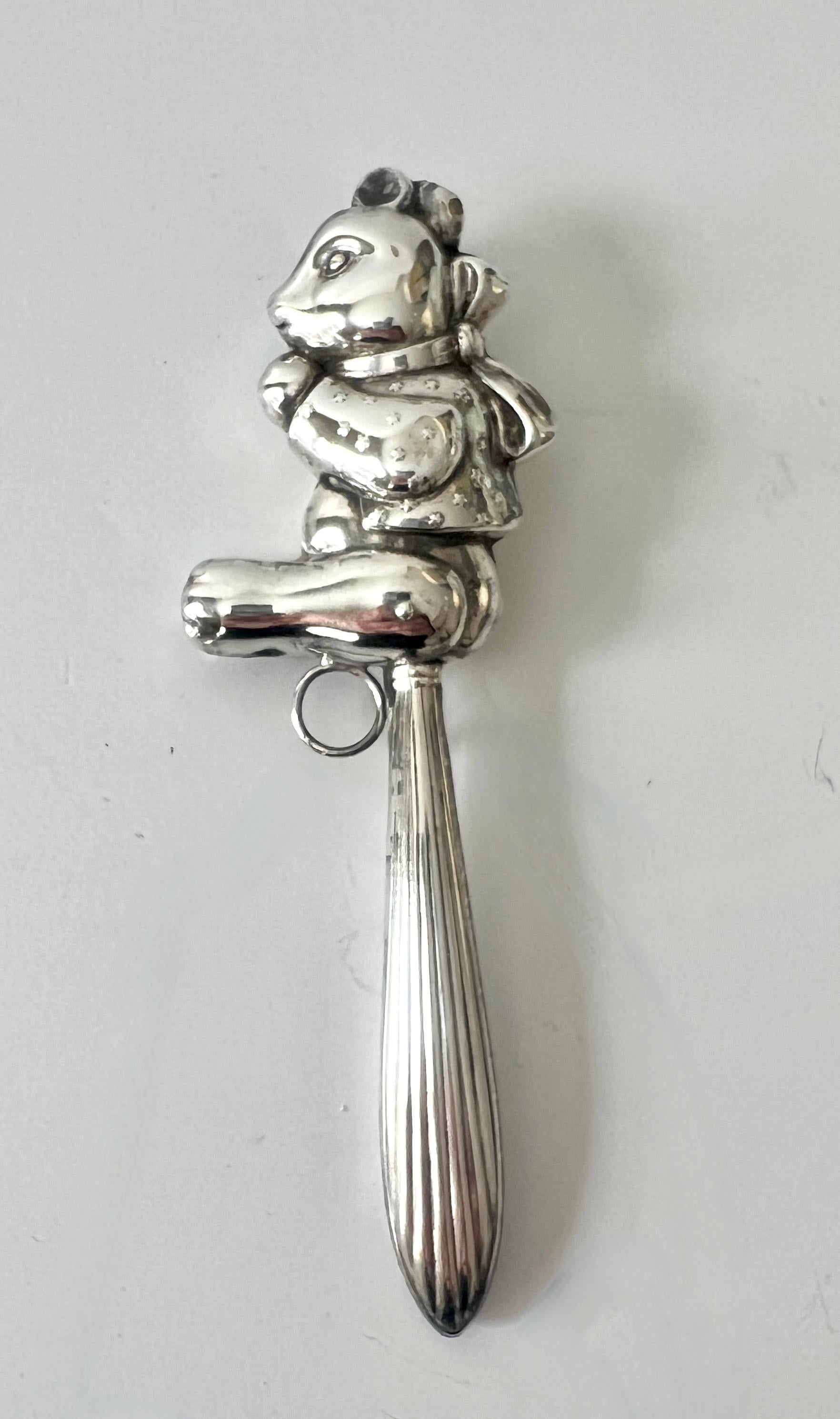 The perfect baby gift!  A sterling silver teddy bear baby rattle.  A well designed and lovely piece, whether used or for decor.  A small ring allows one to add a ribbon - he, she, they, them... the ring could be used for a beaded bracelet to hold