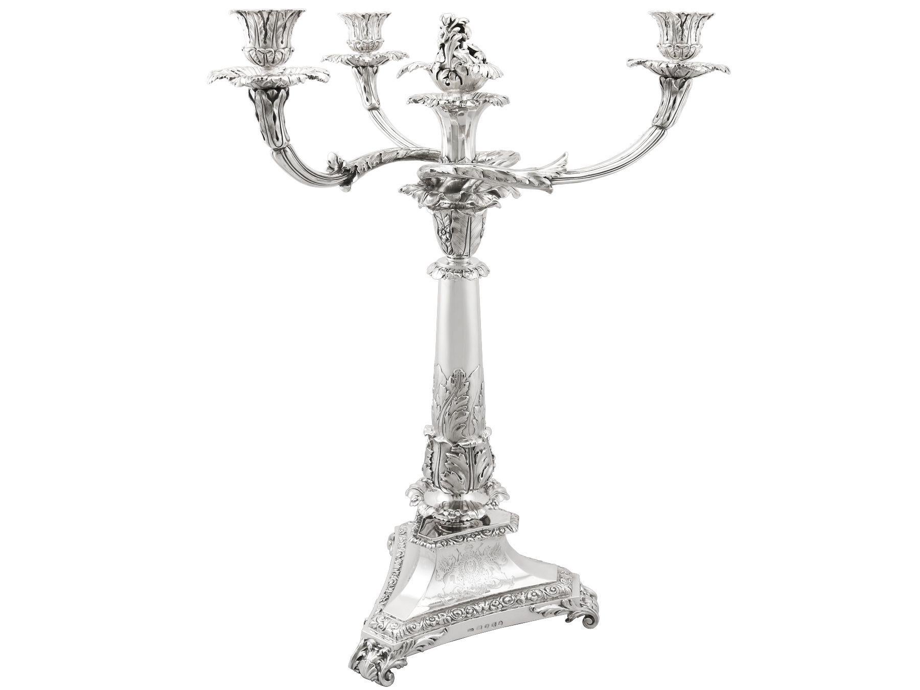 A magnificent, fine and impressive antique George IV English sterling silver three-light candelabrum centrepiece; an addition to our ornamental silverware collection.

This magnificent antique English sterling silver three light candelabrum has a
