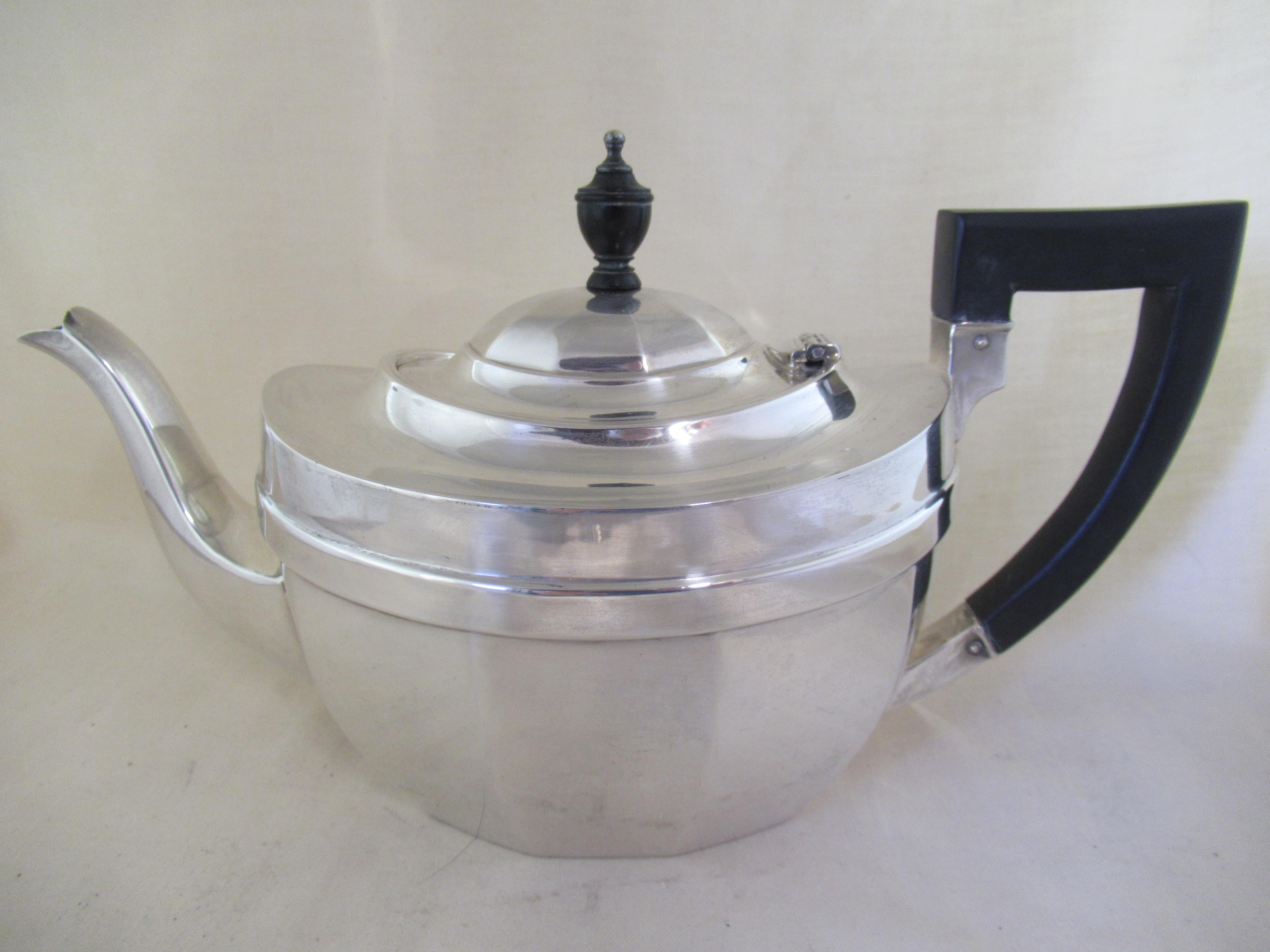 Sterling Silver THREE PIECE TEASET - TEAPOT, SUGAR & CREAM
All three pieces are by Barker Brothers, but the teapot and sugar bowl have a different set of hallmarks to the cream jug.

Teapot & Sugar Bowl:- 3 Sheaves & Sword - Assay office Mark at