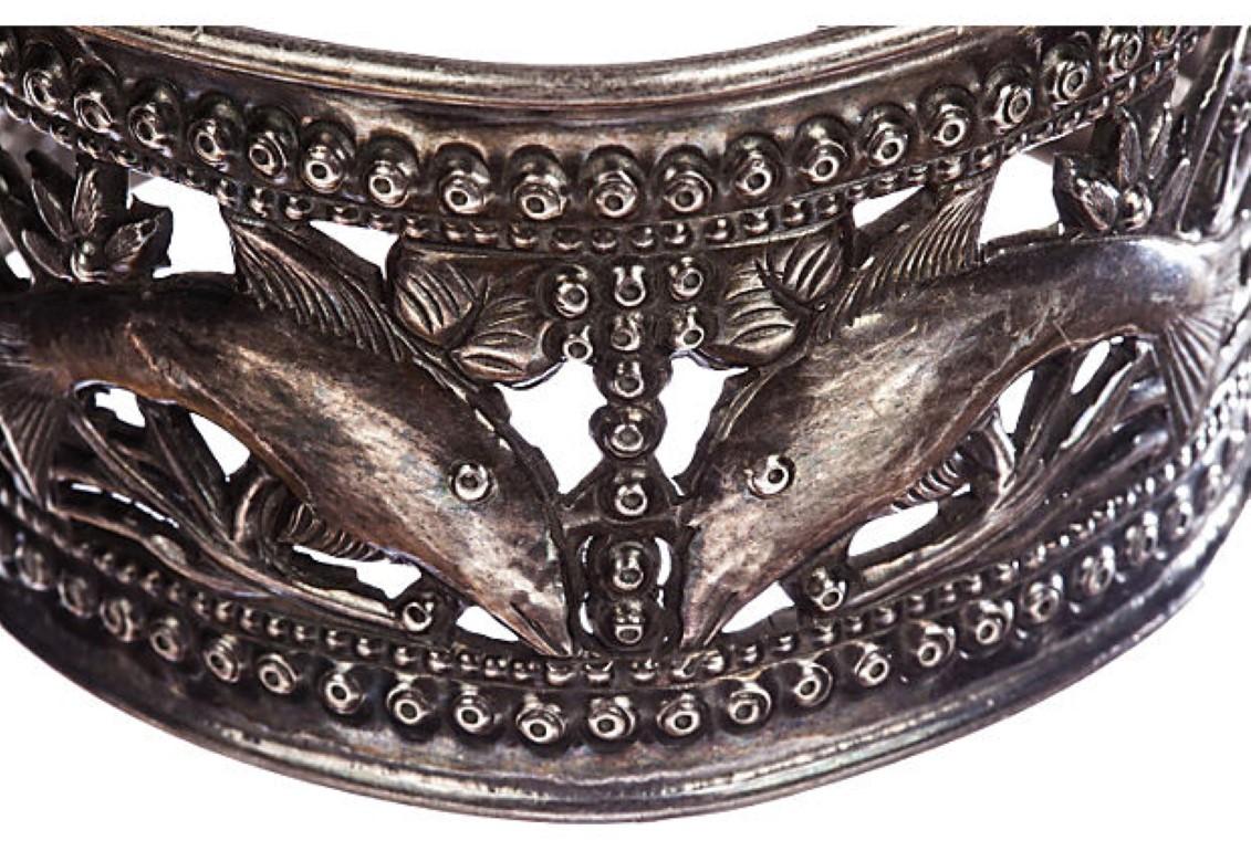 1970s handmade sterling silver repoussé fish cutout bracelet. Interior, 2.5” x 2.25”; back opening, 1.125”. Weight: 48.6 grams. Stamped, “925” for sterling silver and acid tested.
