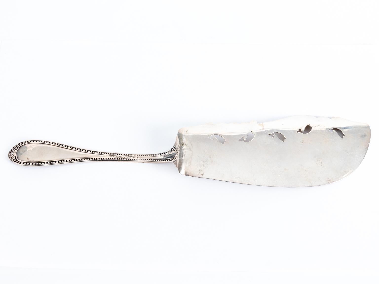 Beautiful made for Tiffany and Co. hand engraved server depicts beautiful engraving skills with jumping cut out fish, circa 1900s. This was made during the late 19th century and does have a monogram on the handle. It weighs 3.865 troy ounces. Made