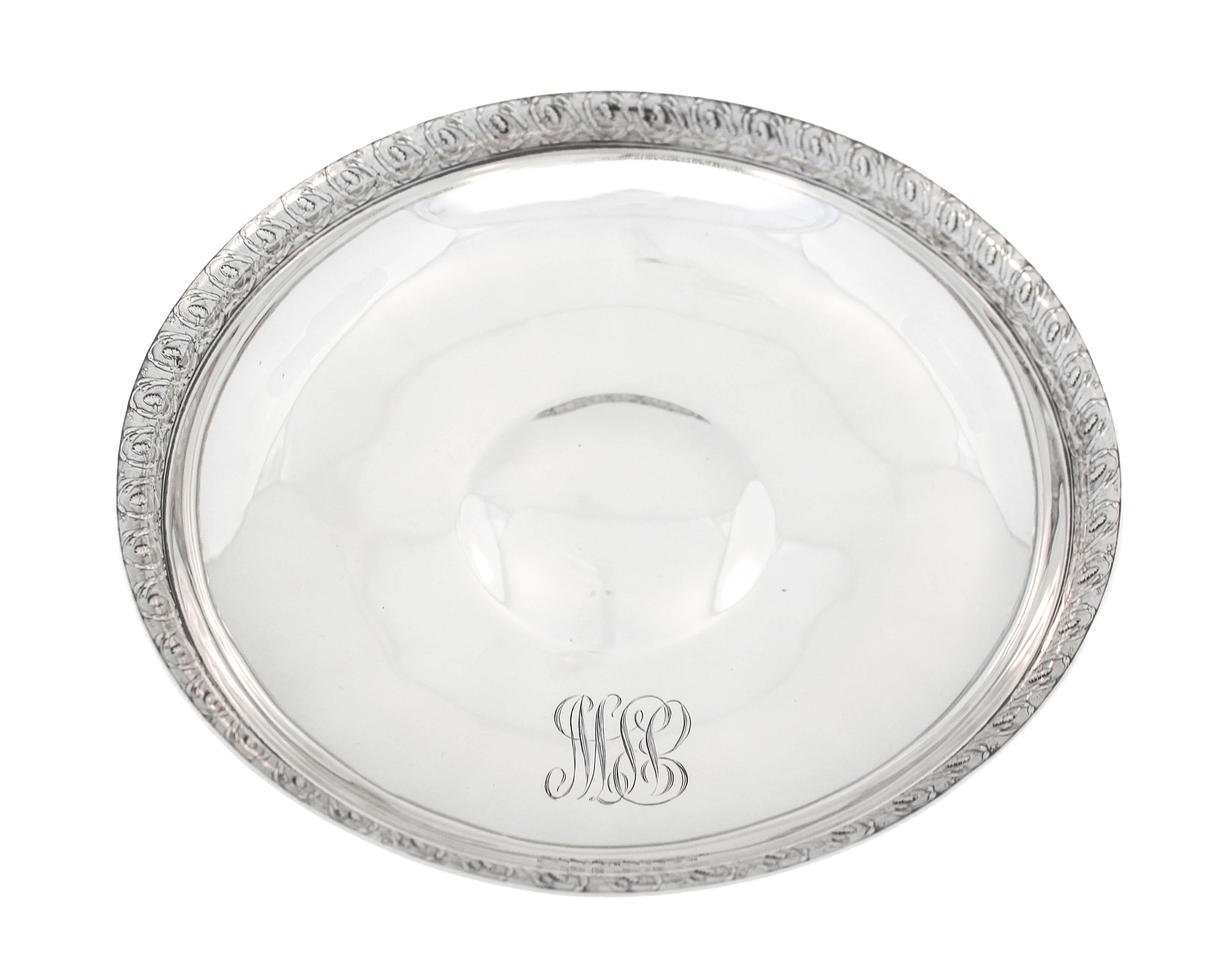 Being offered is a sterling silver footed-bowl by the world renowned Tiffany and Co.  There is a floral motif around the base of the pedestal and again around the edge of the bowl.  The design is twice as large on the top as it is around the base. 