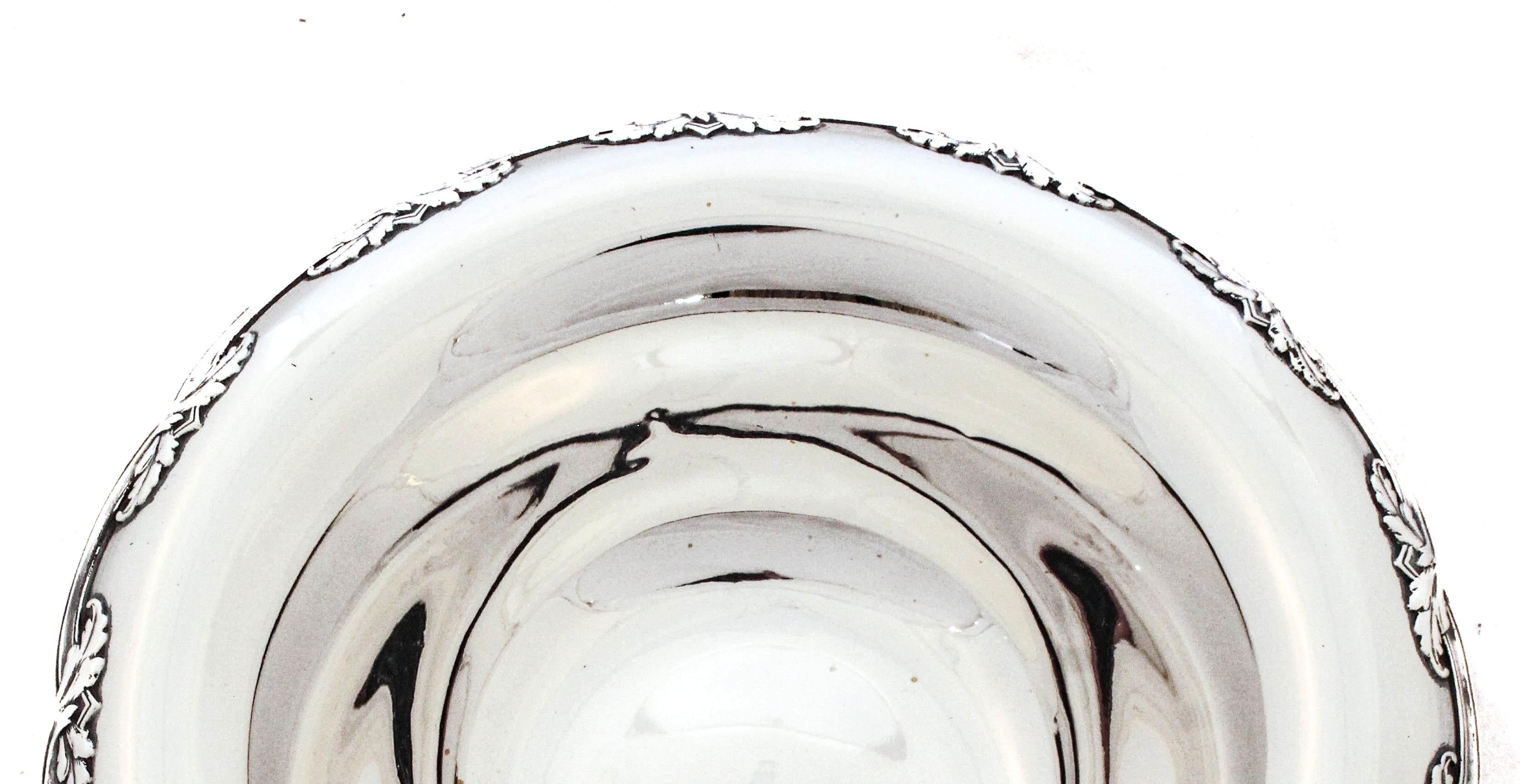 Being offered is a sterling silver bowl by the world renowned Tiffany & Company.  It has a scalloped rim that folds over with an  interconnecting leaf design at each indentation.  It’s a nice size bowl bigger than a candy dish but smaller than a