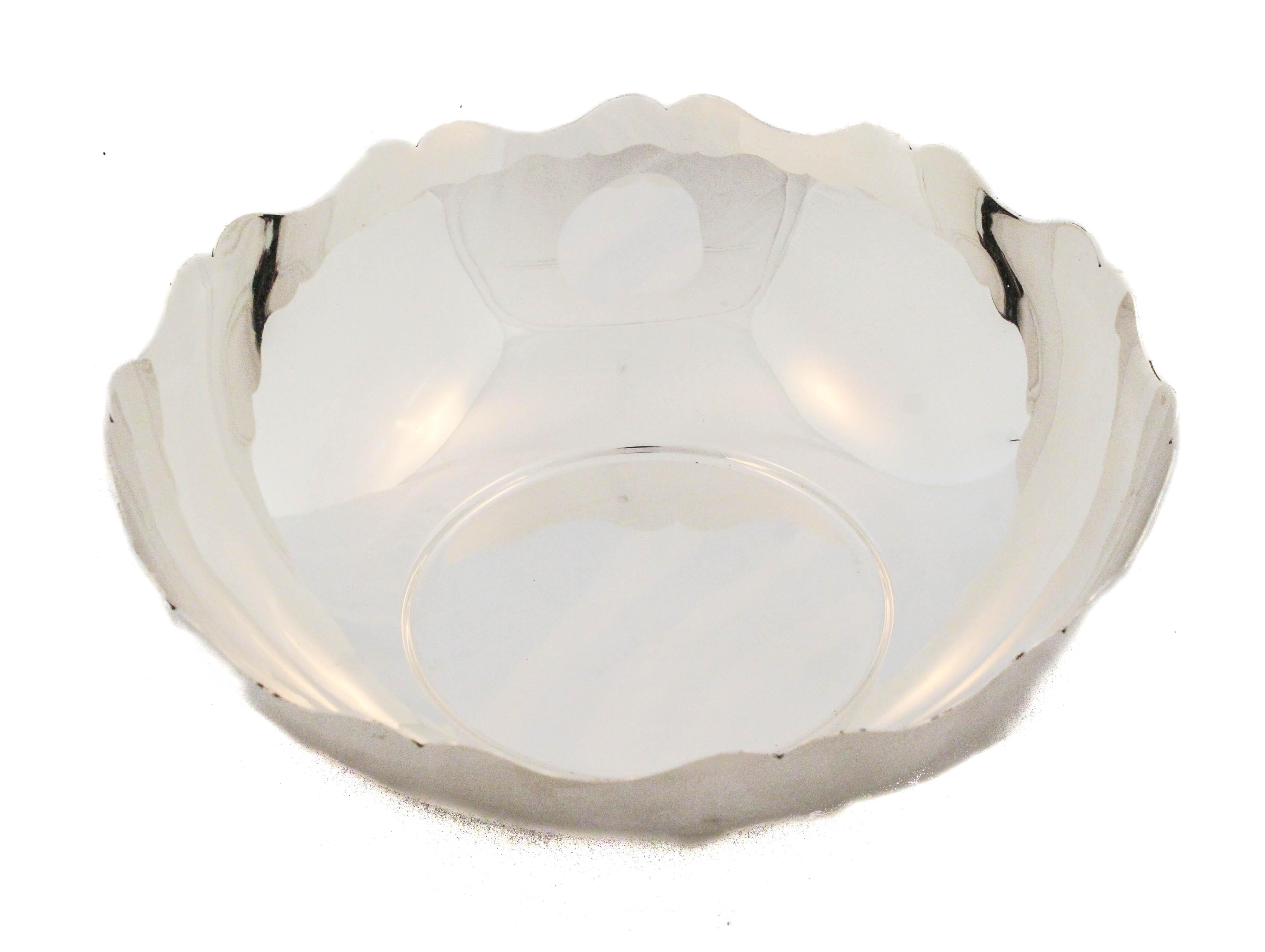 This elegant Mid-Century Modern bowl by Tiffany & Co. measures 8 inches in diameter and 3 inches high. Crafted in sterling silver, the design is clean and minimalist, with a beautifully scalloped rim that adds subtle sophistication without any