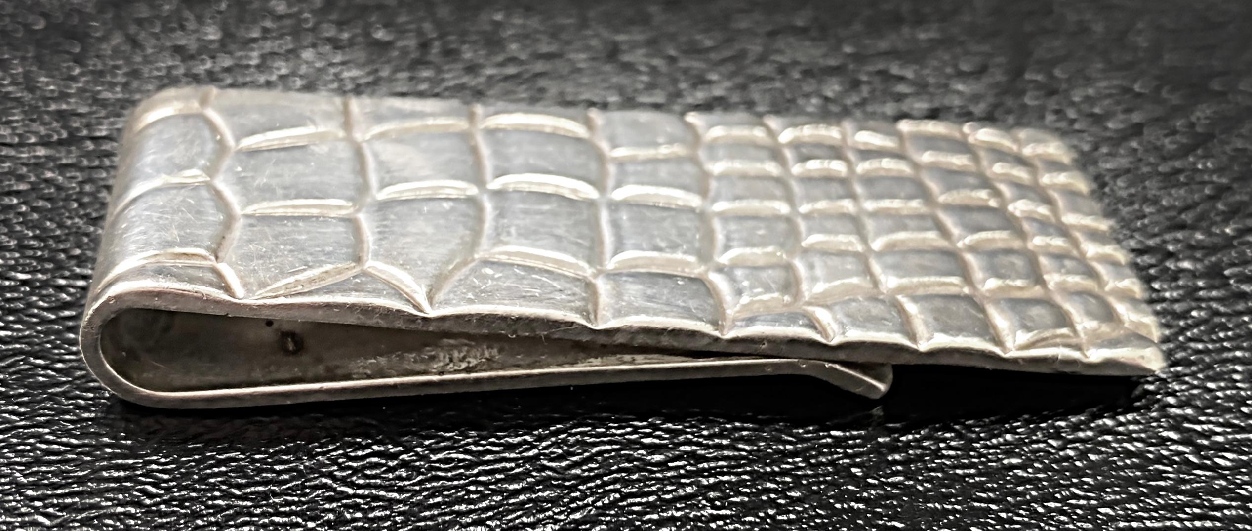 Sterling Silver Tiffany & Co. Faux Crocodile Money Clip, 1950s

Offered for sale is a rare and highly sought-after gentleman's alligator crocodile pattern sterling silver Tiffany Studios money clip dating from the 1950s.
