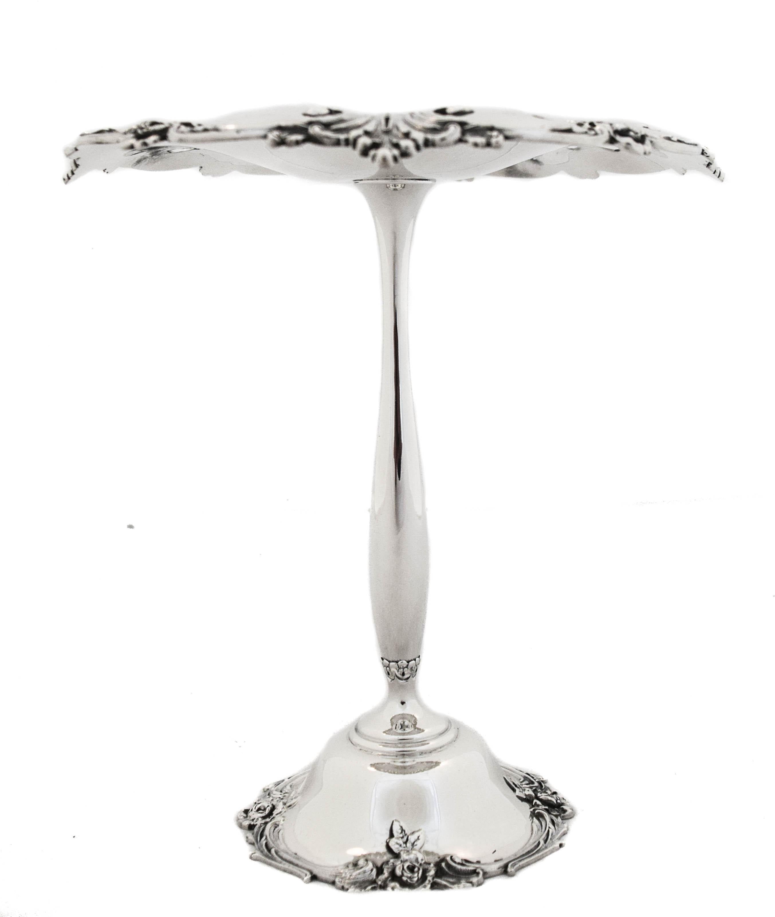 Being offered is a sterling silver compote manufactured by the world renowned Tiffany & Company.  It has a scalloped rim — both on top and on the base with flower’s interspersed.  There is a cutout paisley design that decorates the edge.  Notice the