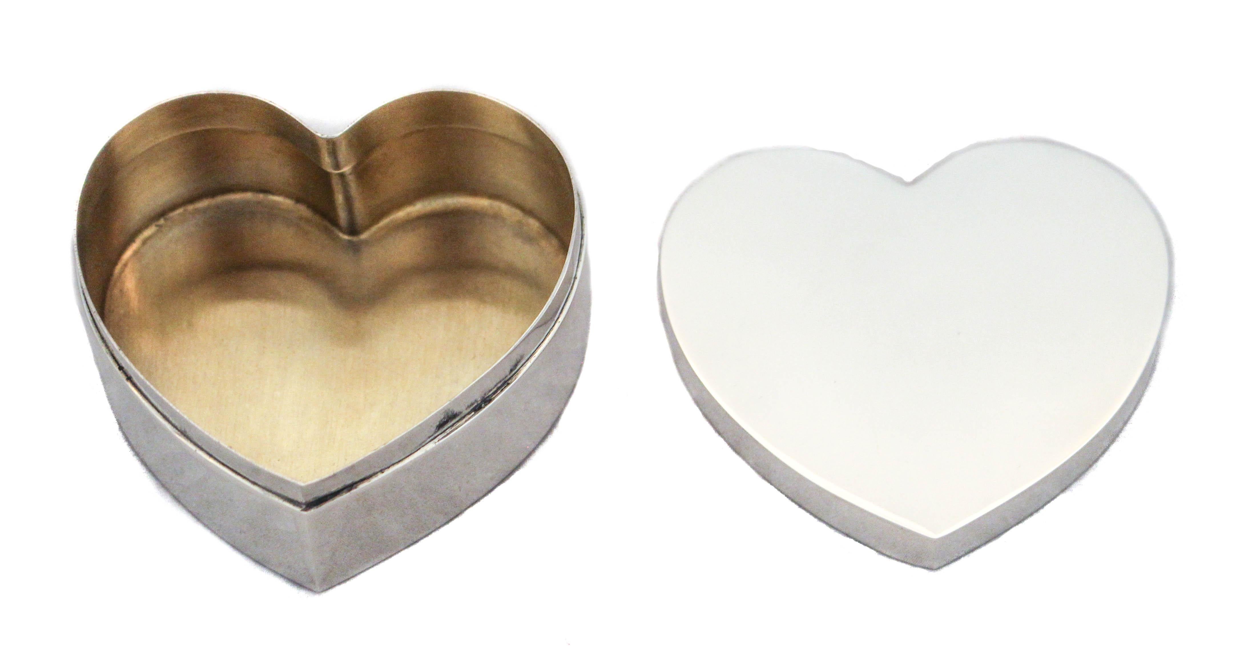 Love is in the air with this Tiffany and Co sterling silver heart box. A quintessential Mid-Century feel and look; sleek and contemporary. This can be used as a jewelry box or simply as a decorative piece.