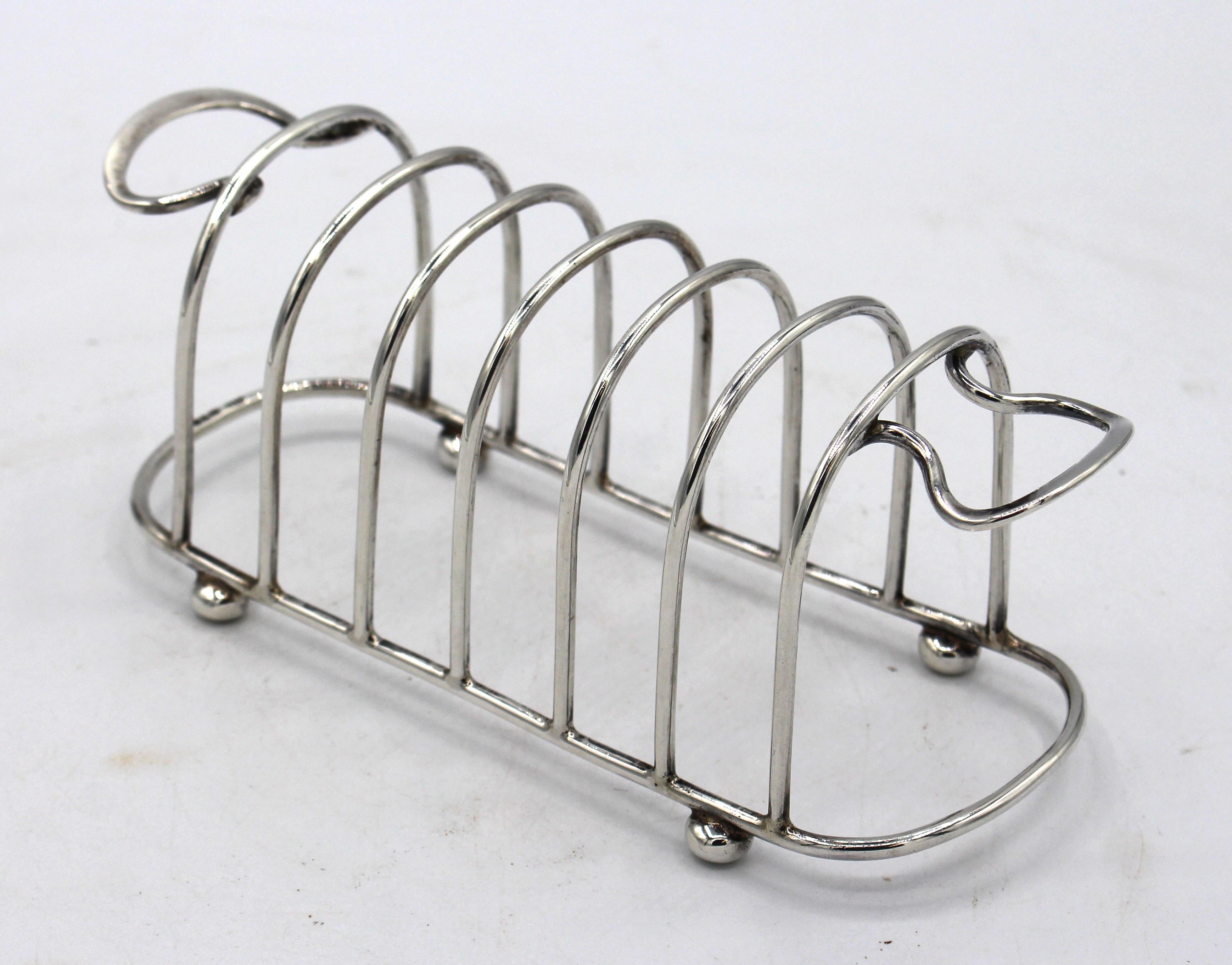 Sterling silver toast rack, Chester, England, 1910, by George Unite & Sons. Post-1902 mark. Edward VII period. Ball feet. 3.45 troy oz.
6 5/16