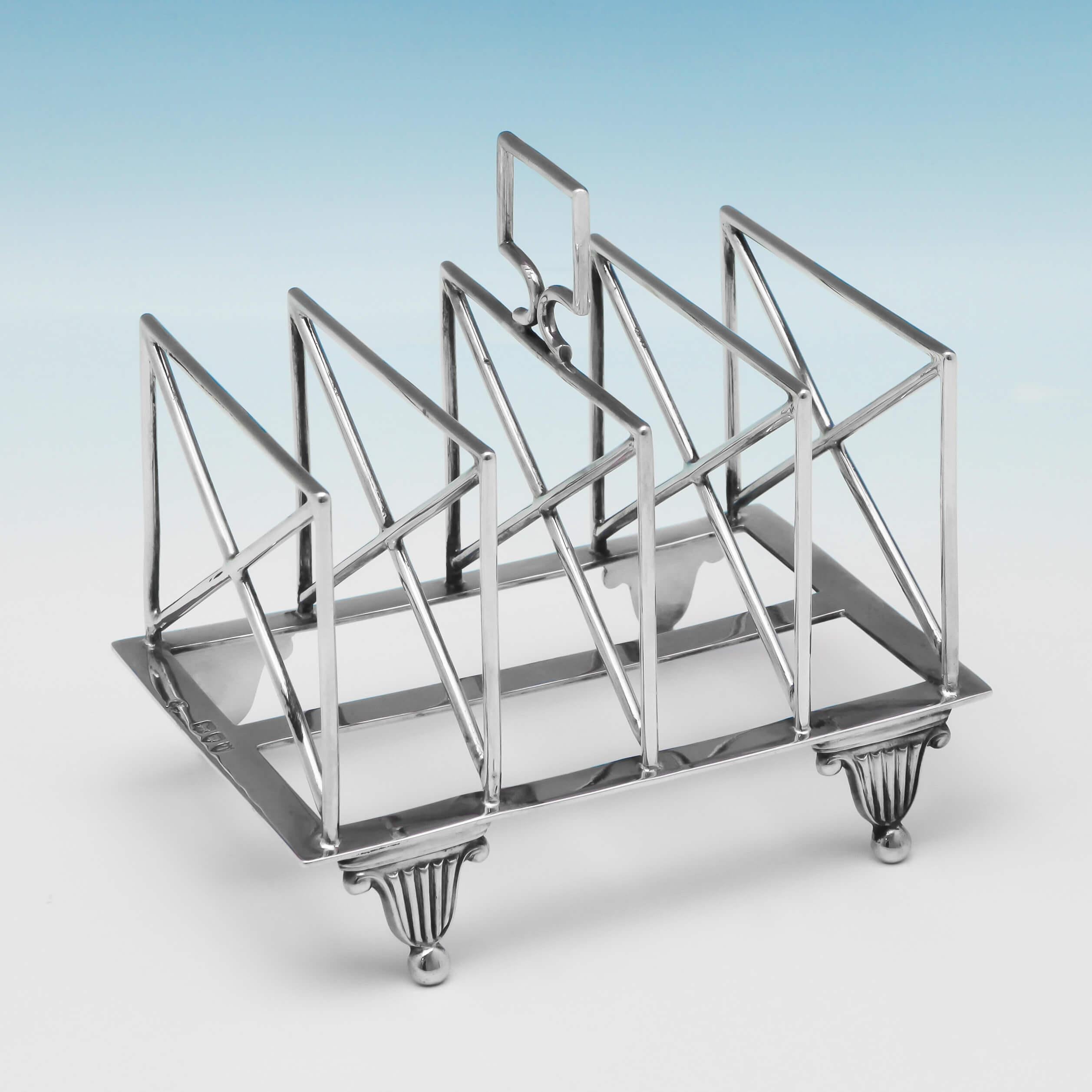 Hallmarked in London, in 1894, by William Hutton & Sons, this handsome, Victorian, antique, sterling Silver toast rack, is plain in style, and has 5 bars for toast. This toast rack measures 5