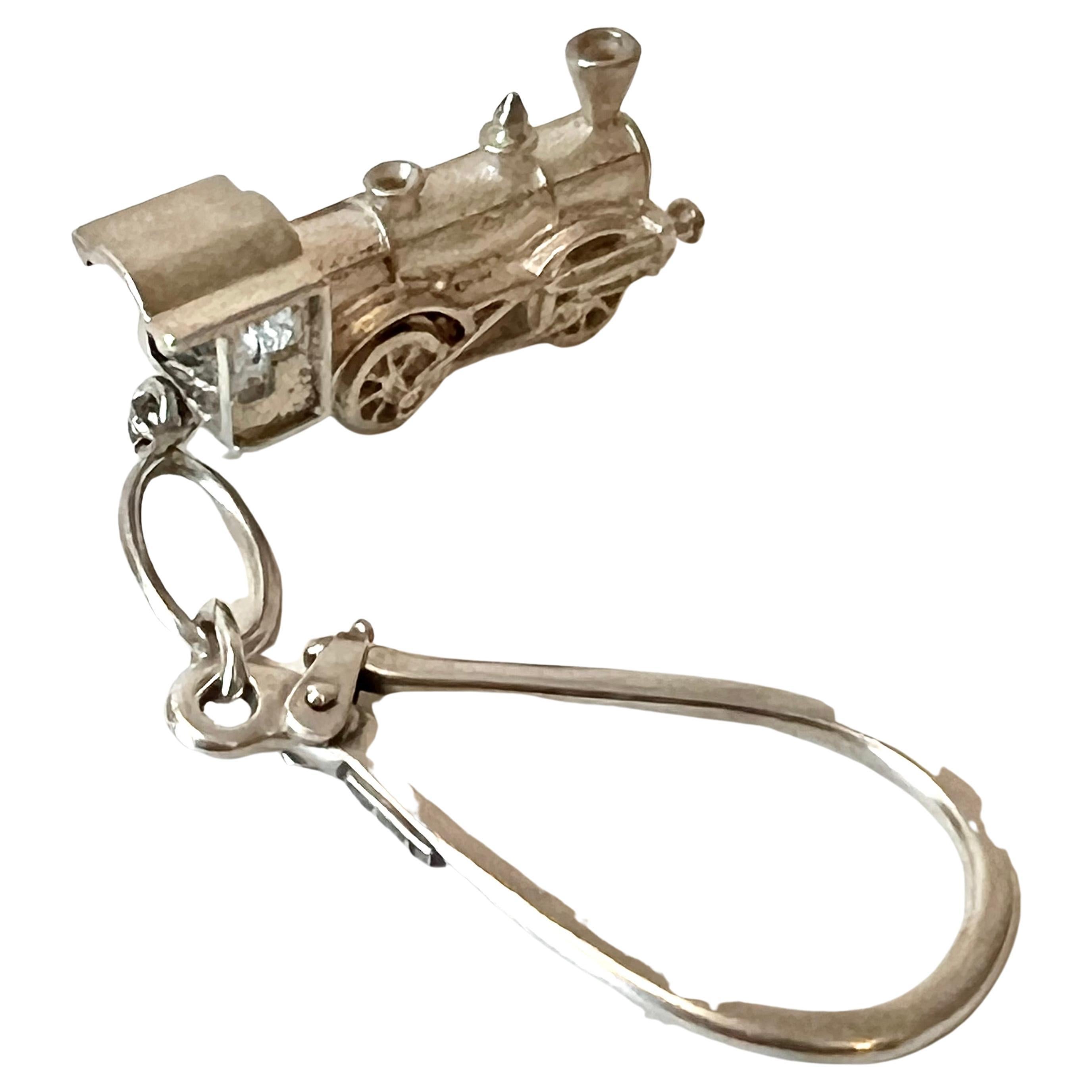 Sterling silver key chain with train or caboose. The key chain looks to be similar to a fine piece, like a Tiffany piece, although it is not.

A large ring with a very secure safety latch to hold keys safely without fail - very nice and wonderful