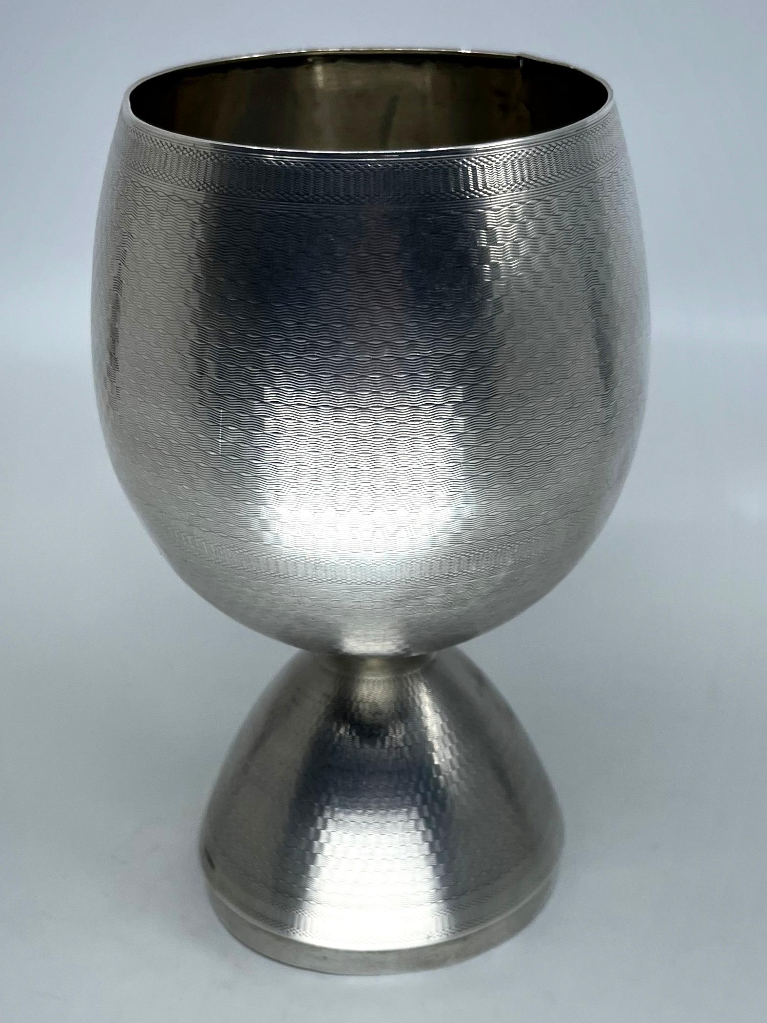 Sterling silver traveling campaign egg chalice. Mid 19th century engine turned metamorphic egg shaped chalice for the gentlemen on campaign with engraved cartouche and blank field ready for monogram. Continental, mid 19th century
Dimensions: in cup