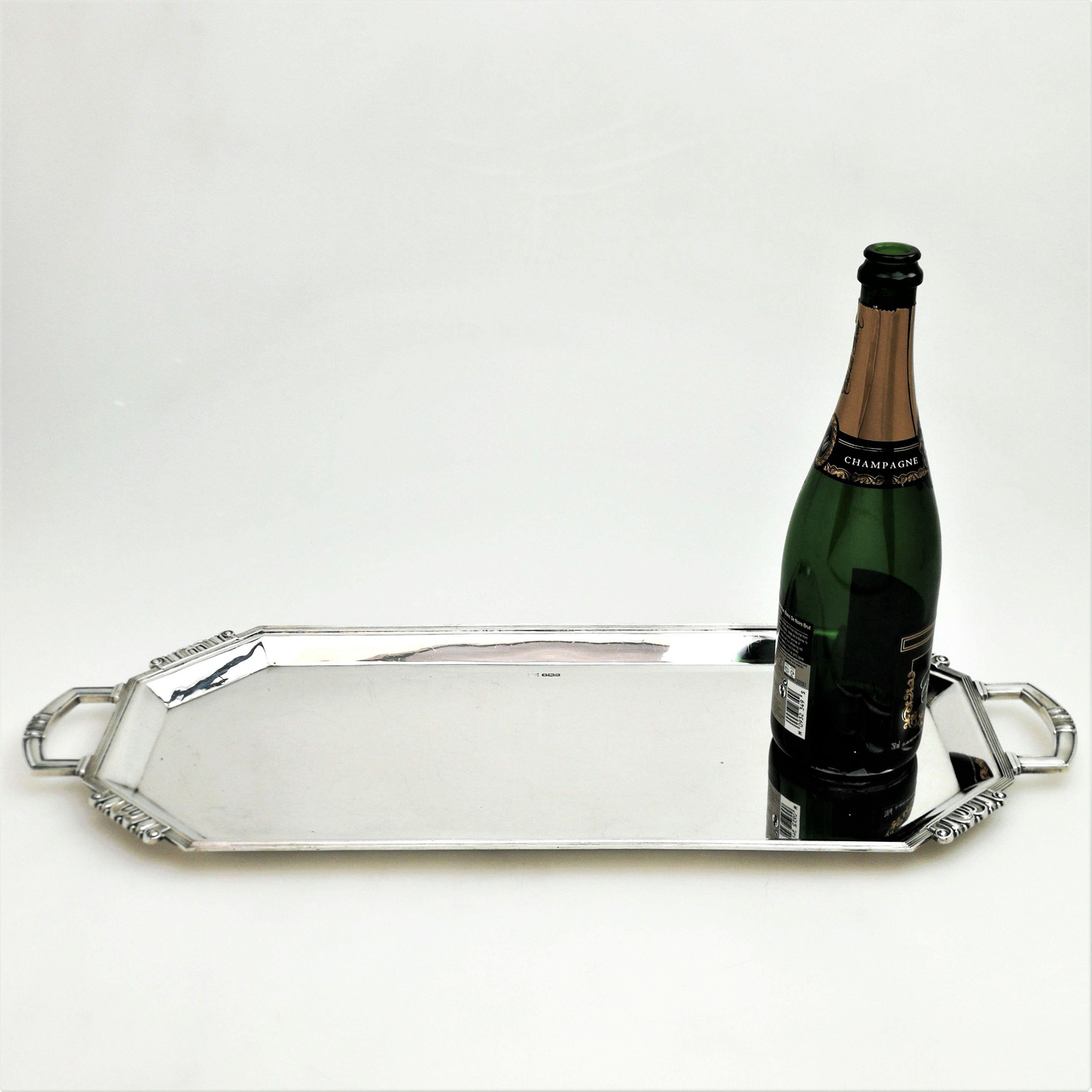 An impressive solid Silver Serving Tray in an elongated rectangular form with two elegant sturdy handles. Suitable as a serving tray, a drinks tray or a sandwich tray. This Tray features an Art Deco style.
 
 Made in Sheffield in 1960 by Walker &