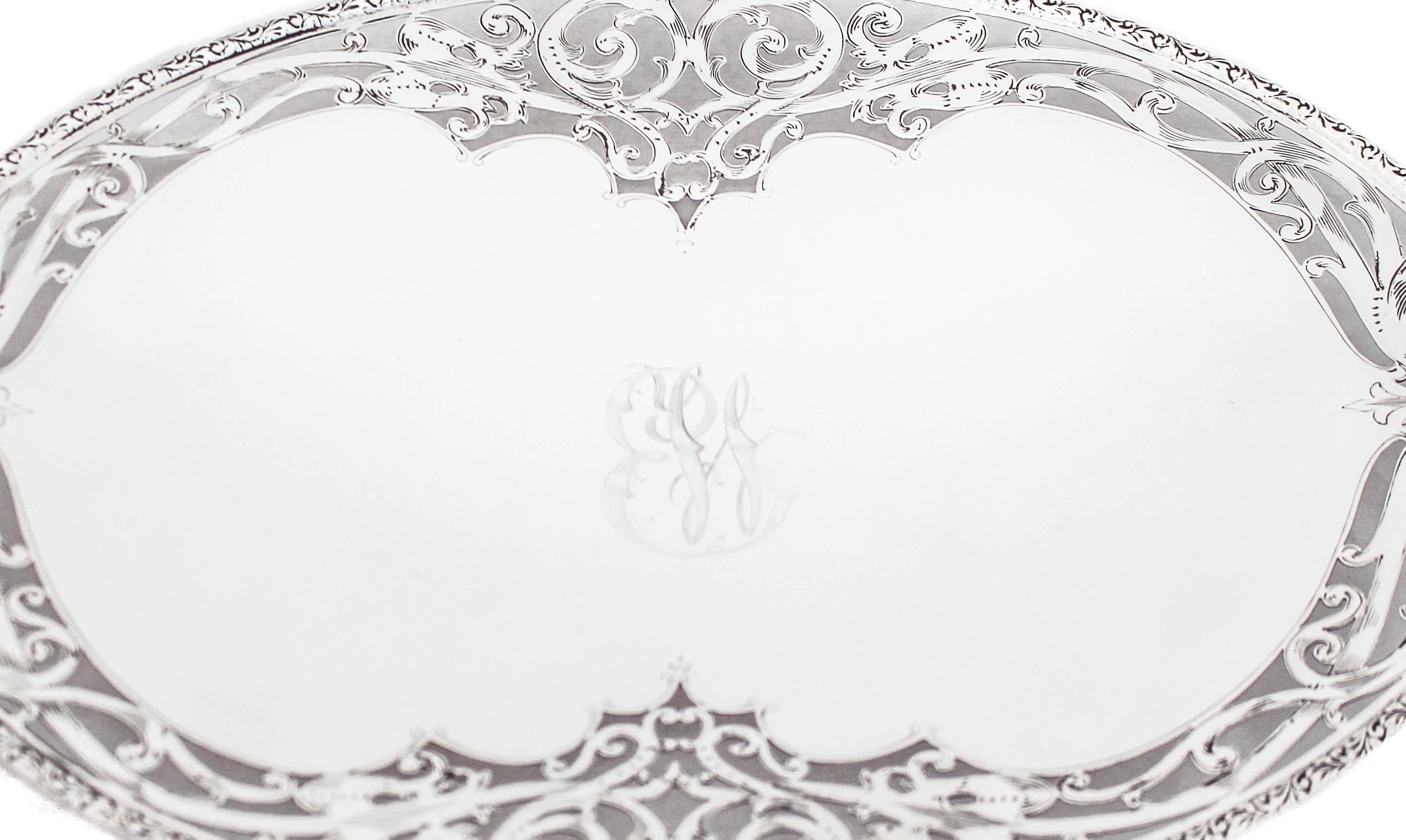 Being offered is a beautiful sterling silver tray with an elegant reticulated design going around the border.  It’s an oval piece with handles on each side and stands on a pedestal.  The entire edge has an Art Nouveau cutout pattern that compliments