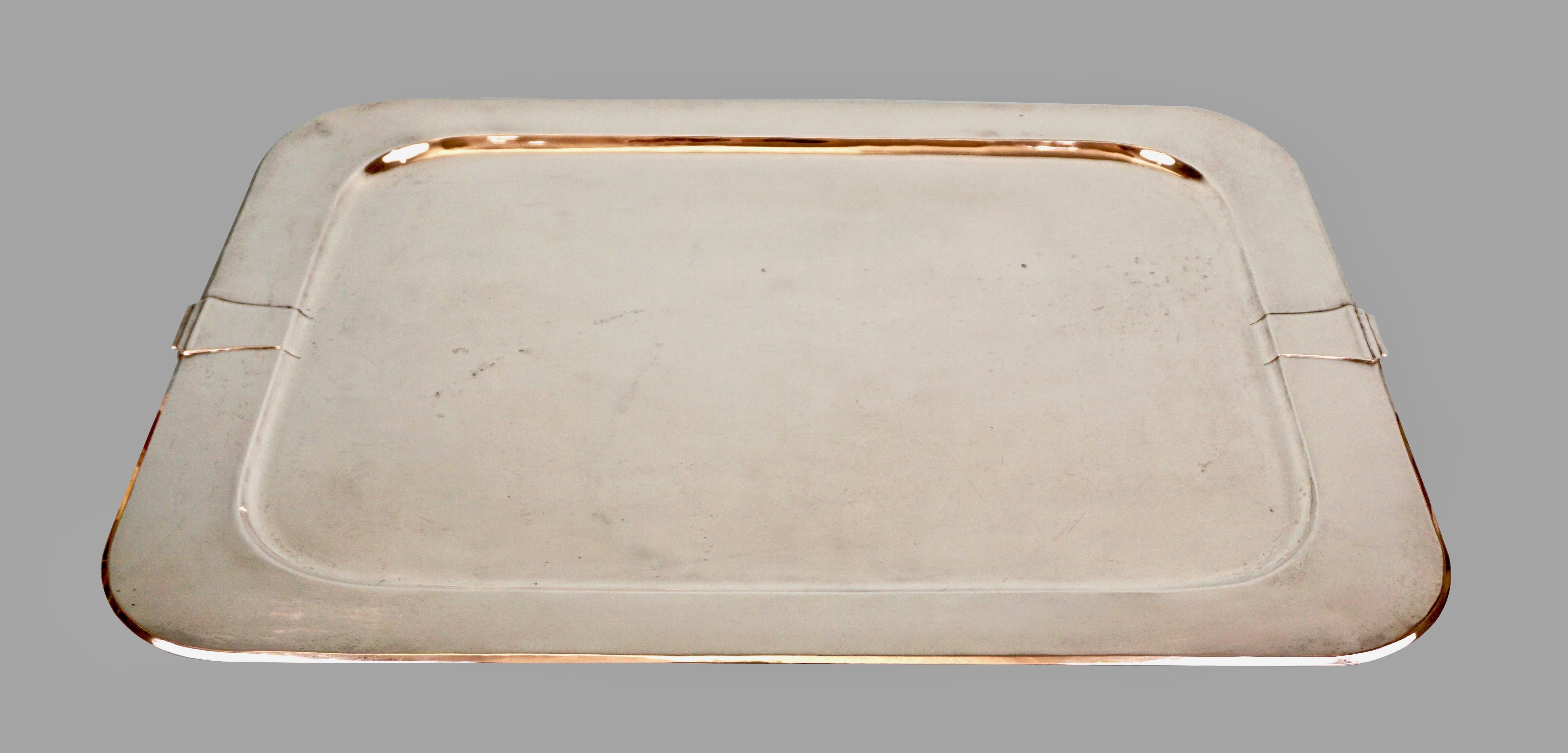 An elegant sterling silver tray of simple form with restrained handles in the art moderne style. Stamped with the Dirk Van Erp windmill mark on the underside and the word sterling. This piece was produced during the period after William Van Erp,