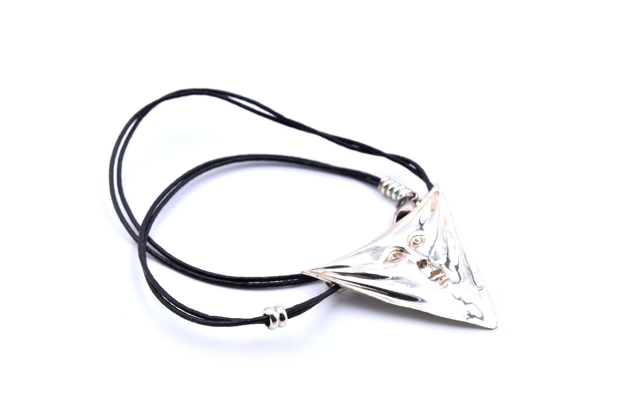 Designer: Sergio Bustamante
Material: sterling silver
Dimensions: pendant measures 46.35mm by 34.70mm and the necklace is 15-inches long
Weight: 14.38 grams
