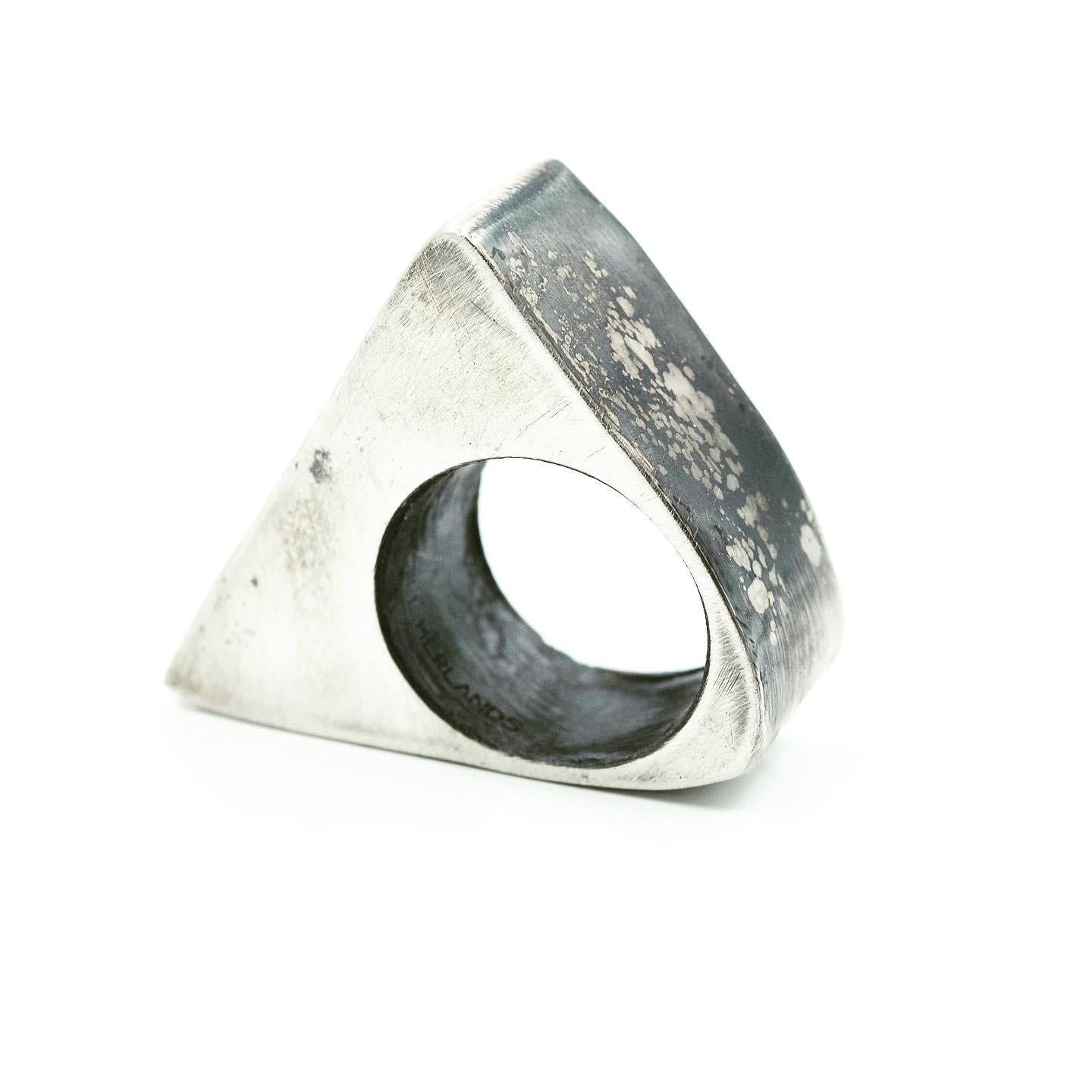 Sterling Silver ‘Triangle’ Ring
 
This piece was created when I was walking through NYC, where I live and work, and I noticed garden with a trellis that sloped up and looked like a triangle. It hit me that I could create a hollow triangle, one of