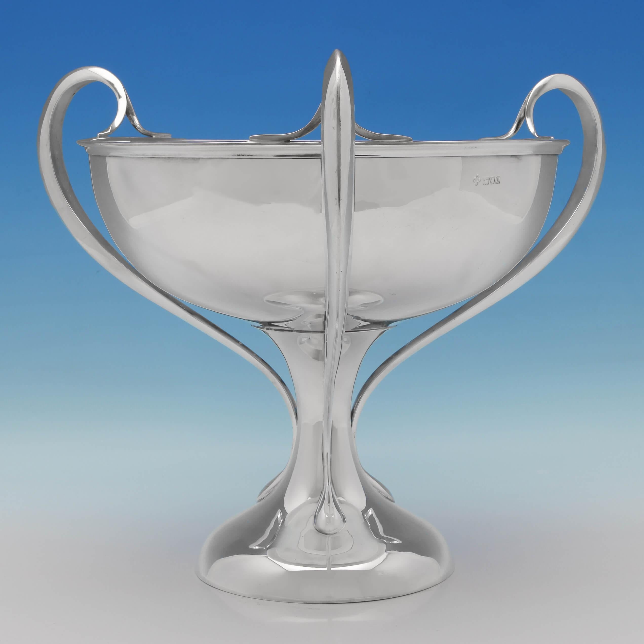 Hallmarked in London in 1906 by William Hutton & Sons, this magnificent and large, Edwardian antique, Art Nouveau sterling silver trophy, has a plain form, with three elegant loop handles. The trophy measures 12.5