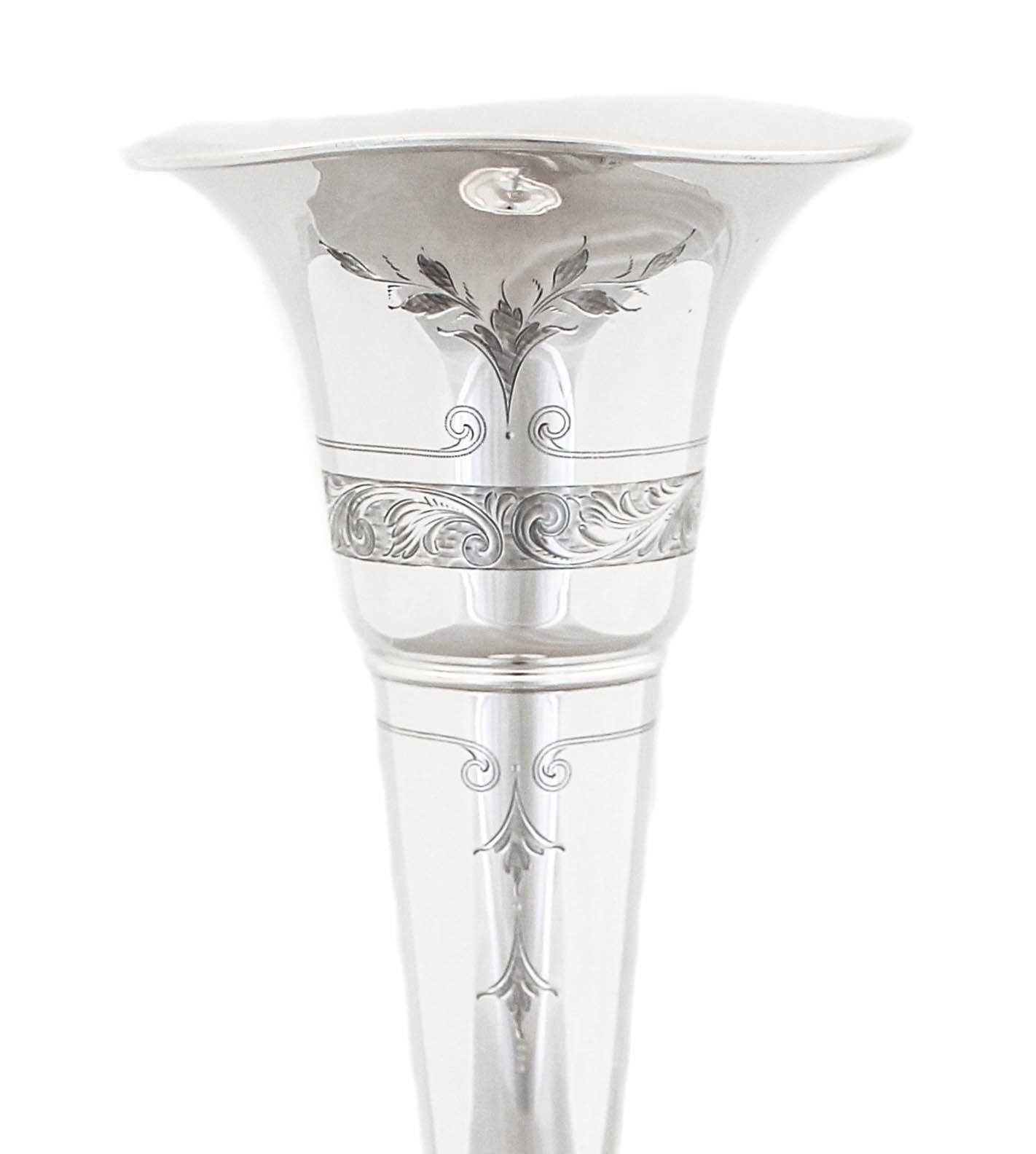 We are happy to offer you this sterling silver trumpet vase by Dominick and Haff. It has a fluted rim and a beautiful etched design around the top. It’s transitional and can work with either modern or traditional decor. Flowers make a room warm and