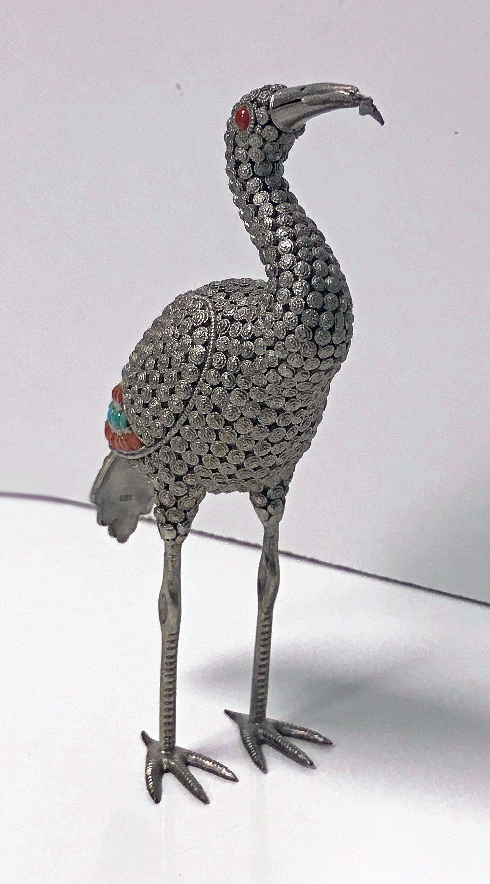 925 sterling silver and multi-color stone inlay Heron, Egret or Emu, probably Chinese, circa 1950. The bird is highly detailed with a fine silver wire work filigree body, wings, and tail and has a fish in its mouth. The silver set with numerous red