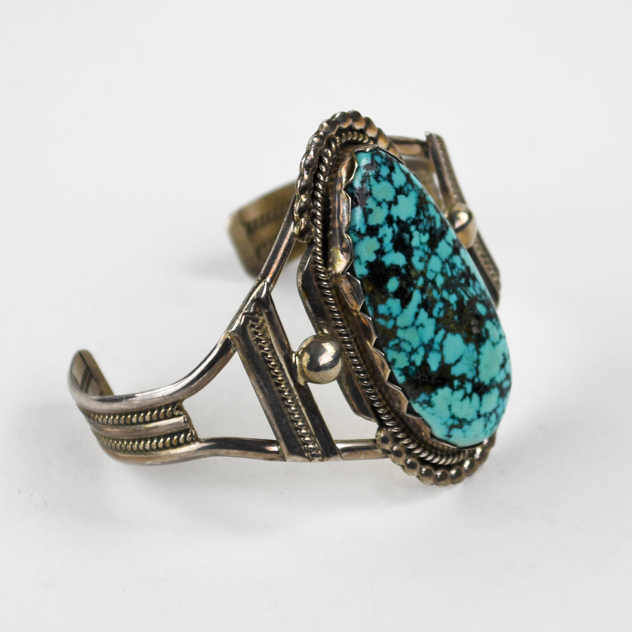 Bracelet en argent sterling avec turquoise.
Pèse 34.4 grammes en poids brut.
Estampillé H. Spencer, Sterling. 
L'attrayante turquoise en forme de toile d'araignée mesure 1,5/8 pouce par 3/4 de pouce.
La partie inférieure du bracelet se plie pour