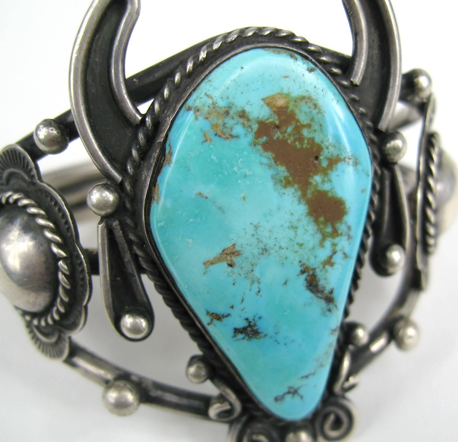 Large scale Turquoise Sterling silver Navajo Bracelet with the Initials FTHI on the inside of the bracelet. Measuring 2.30 in top to bottom x 1.42 inches wide. Tapers down in the back and will fit 6.5 to 7'5 inch wrist has give to make smaller or